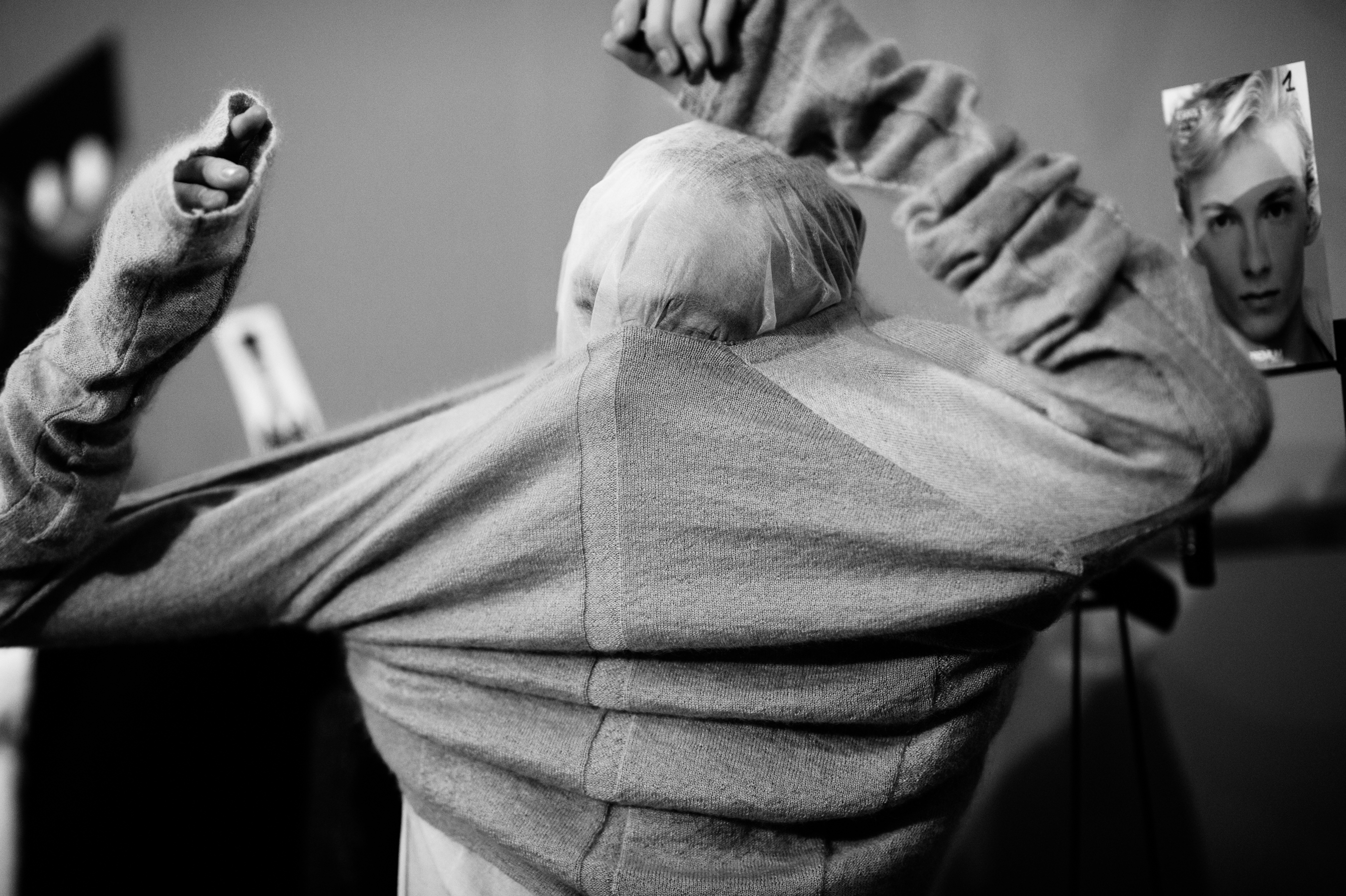 Male model pulling on a shirt