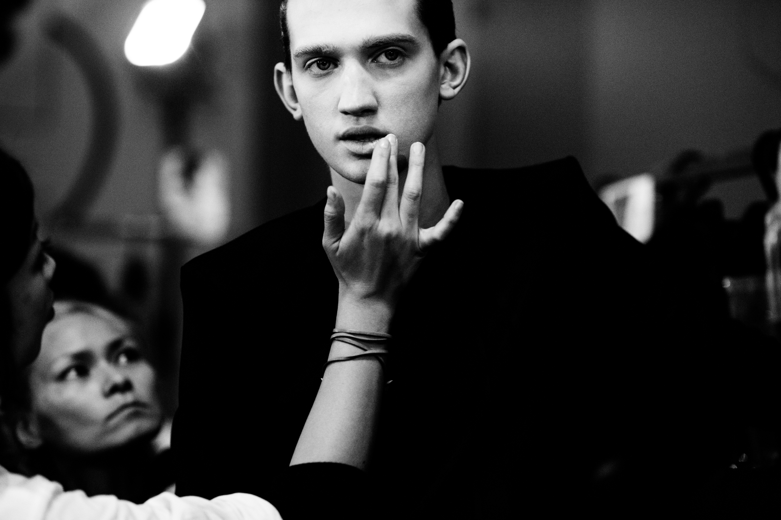 Male model having his makeup done