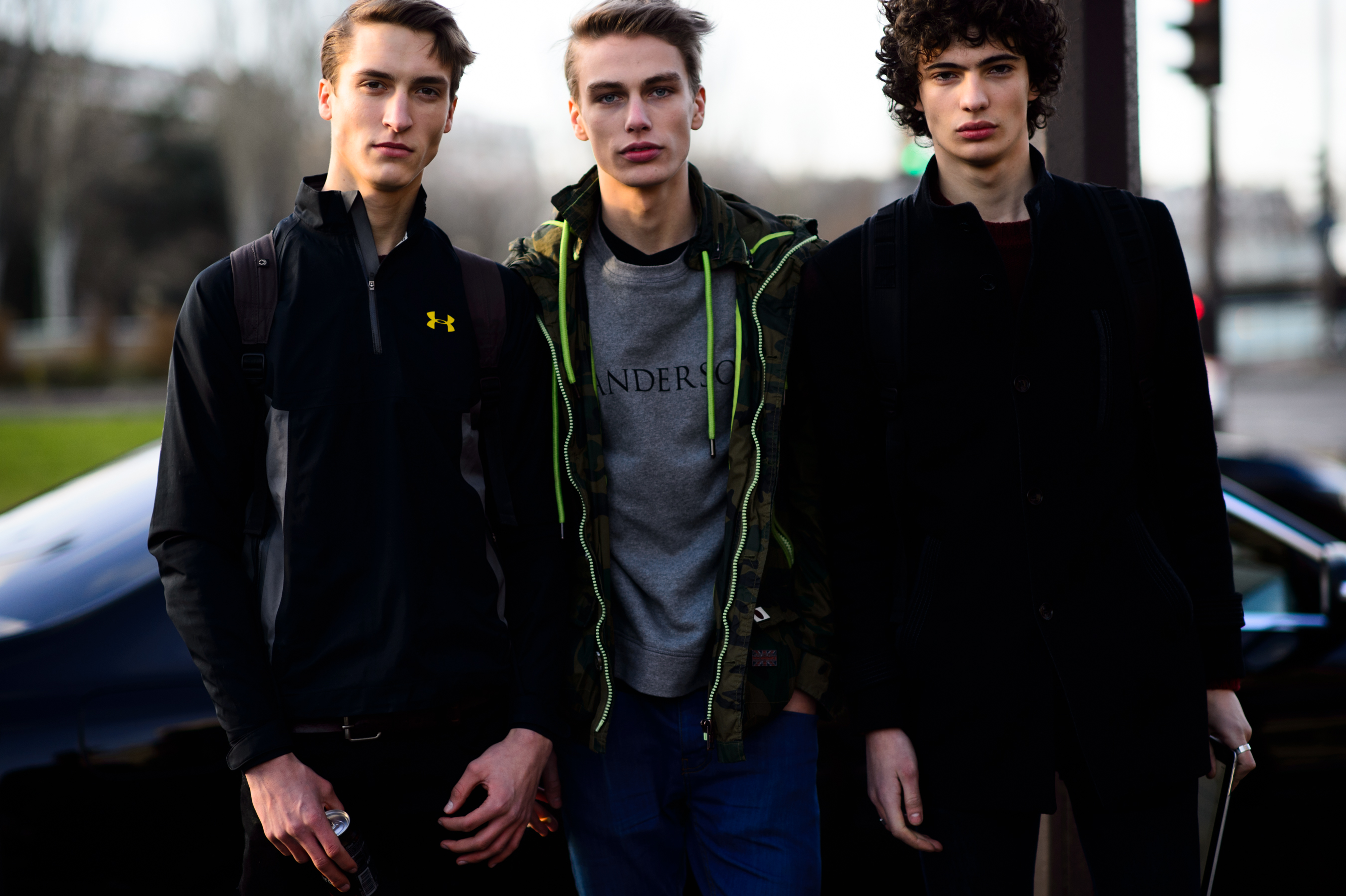 Three male models after a fashion show