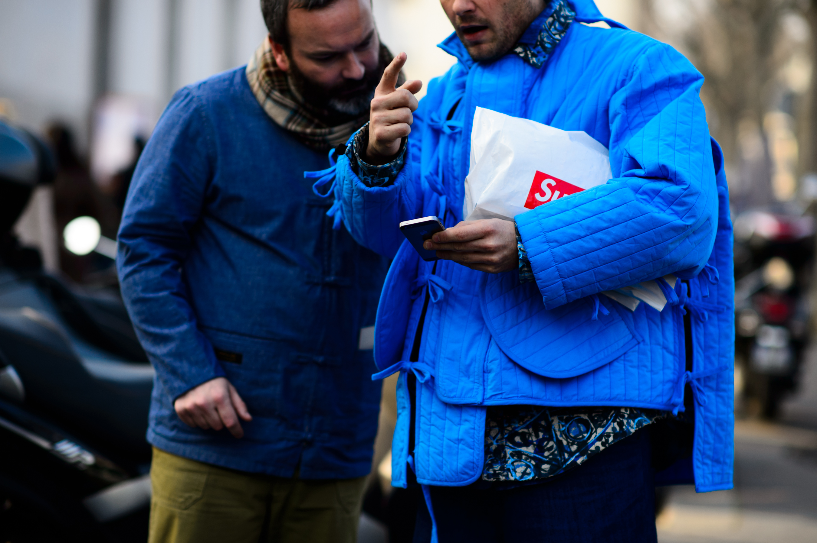 Two men wearing blue jackets
