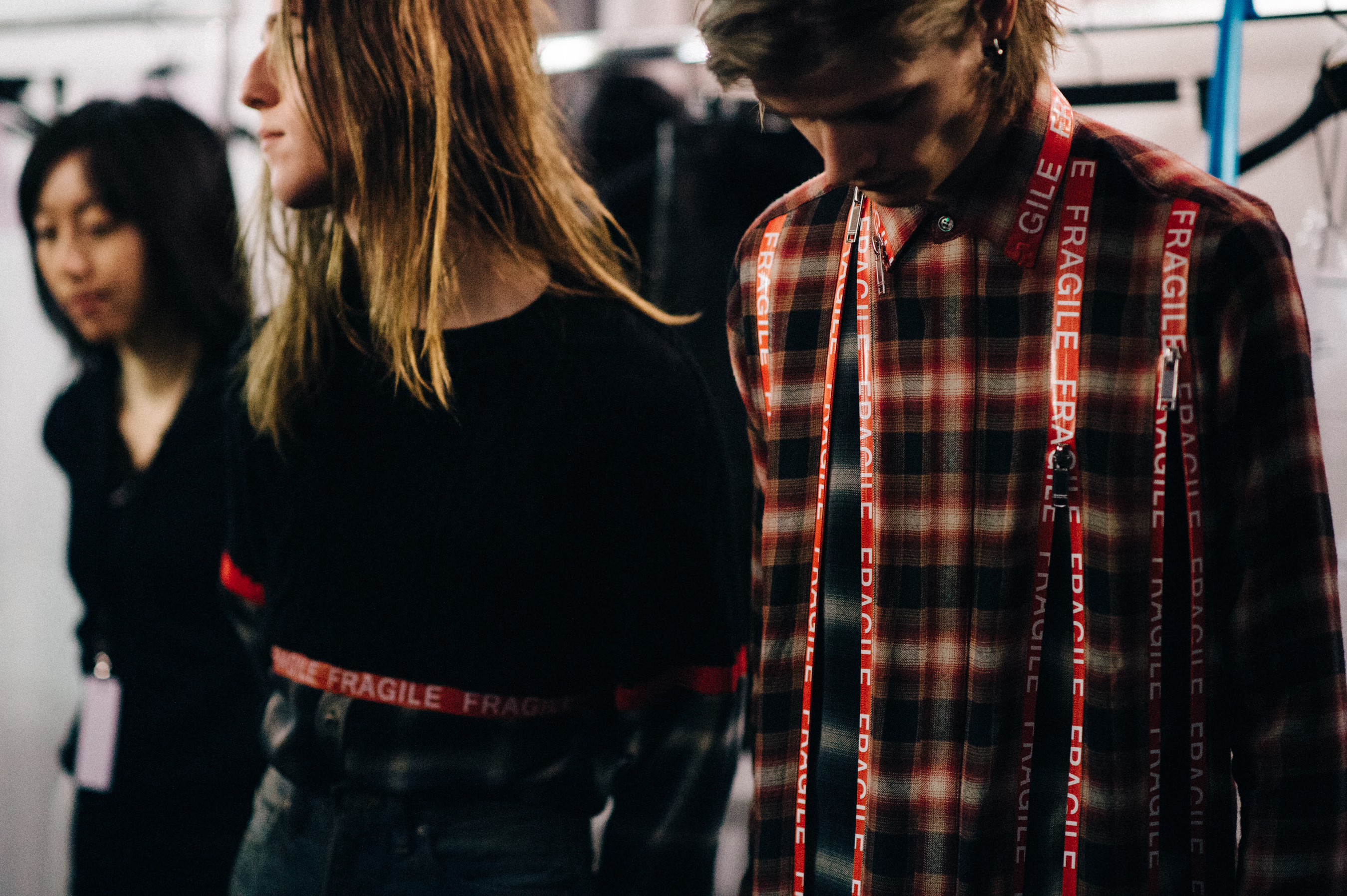 Two male models wearing "Fragile" shirts