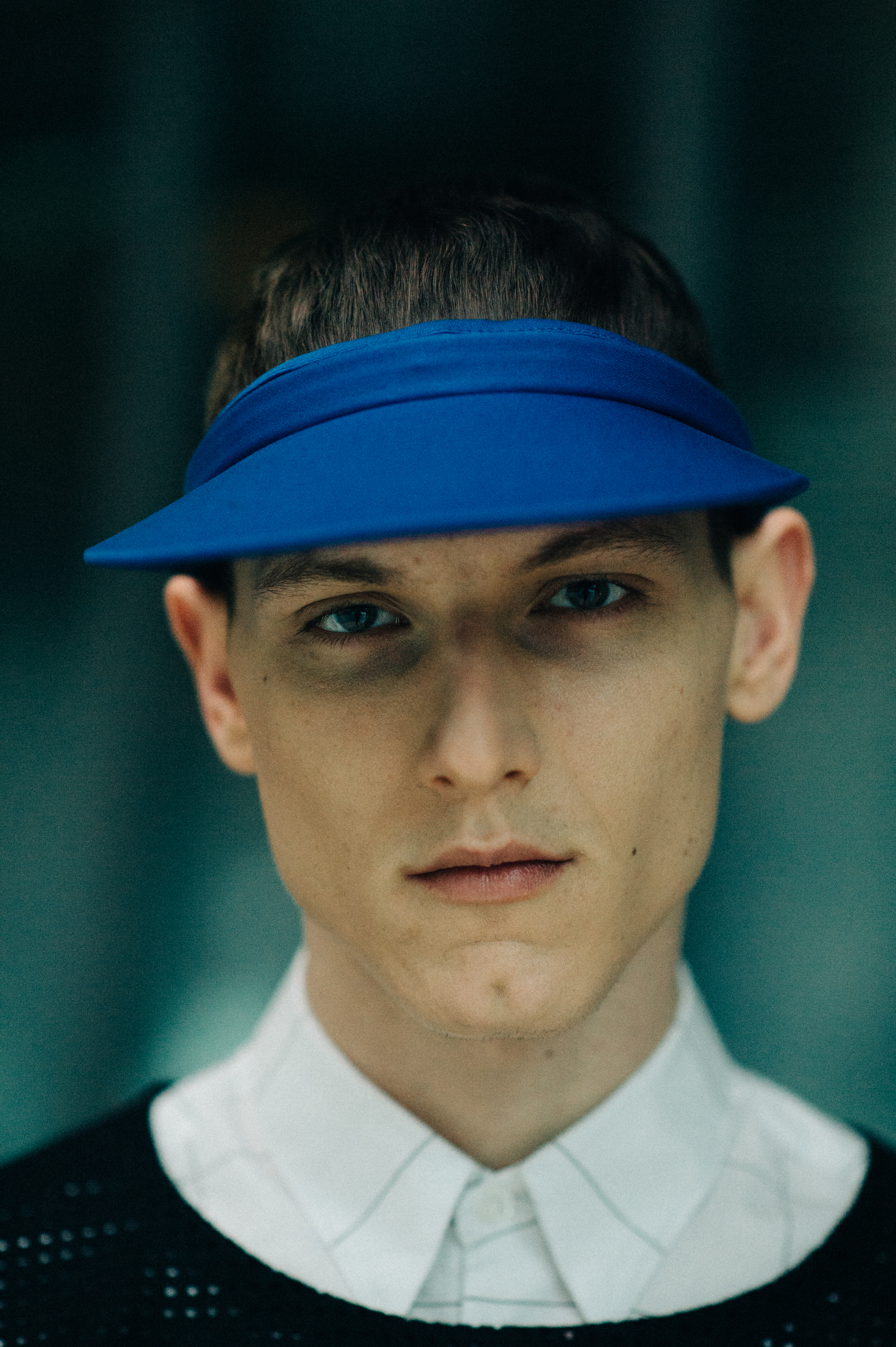 Male model portrait in a blue visor