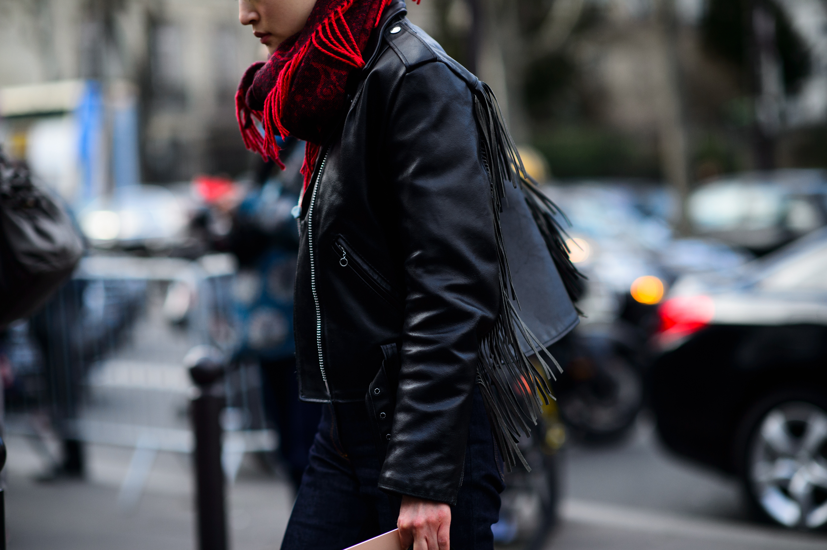 Woman wearing a red scarf and black leather jacket