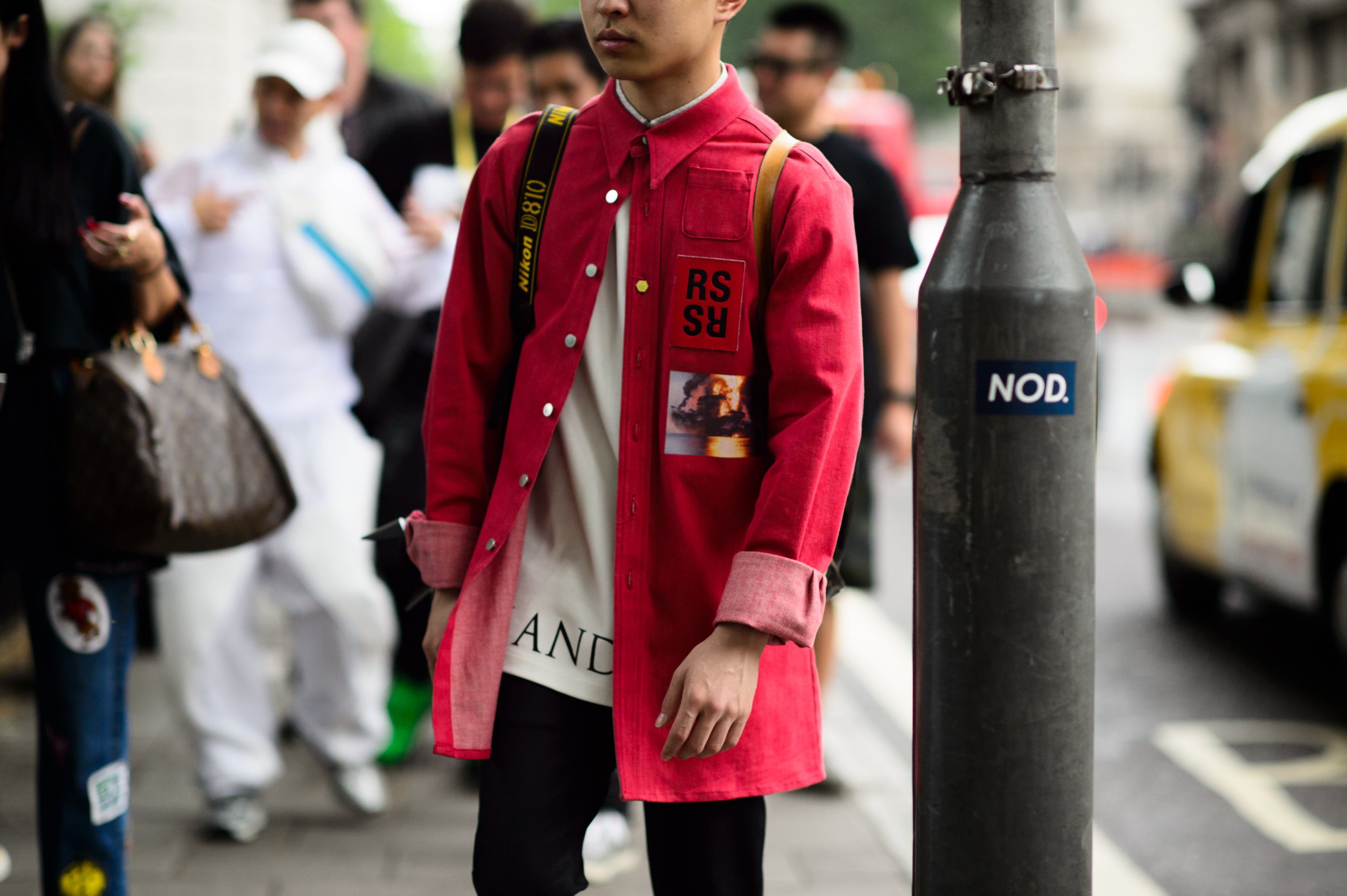 Asian man wearing a Raf Simons shirt