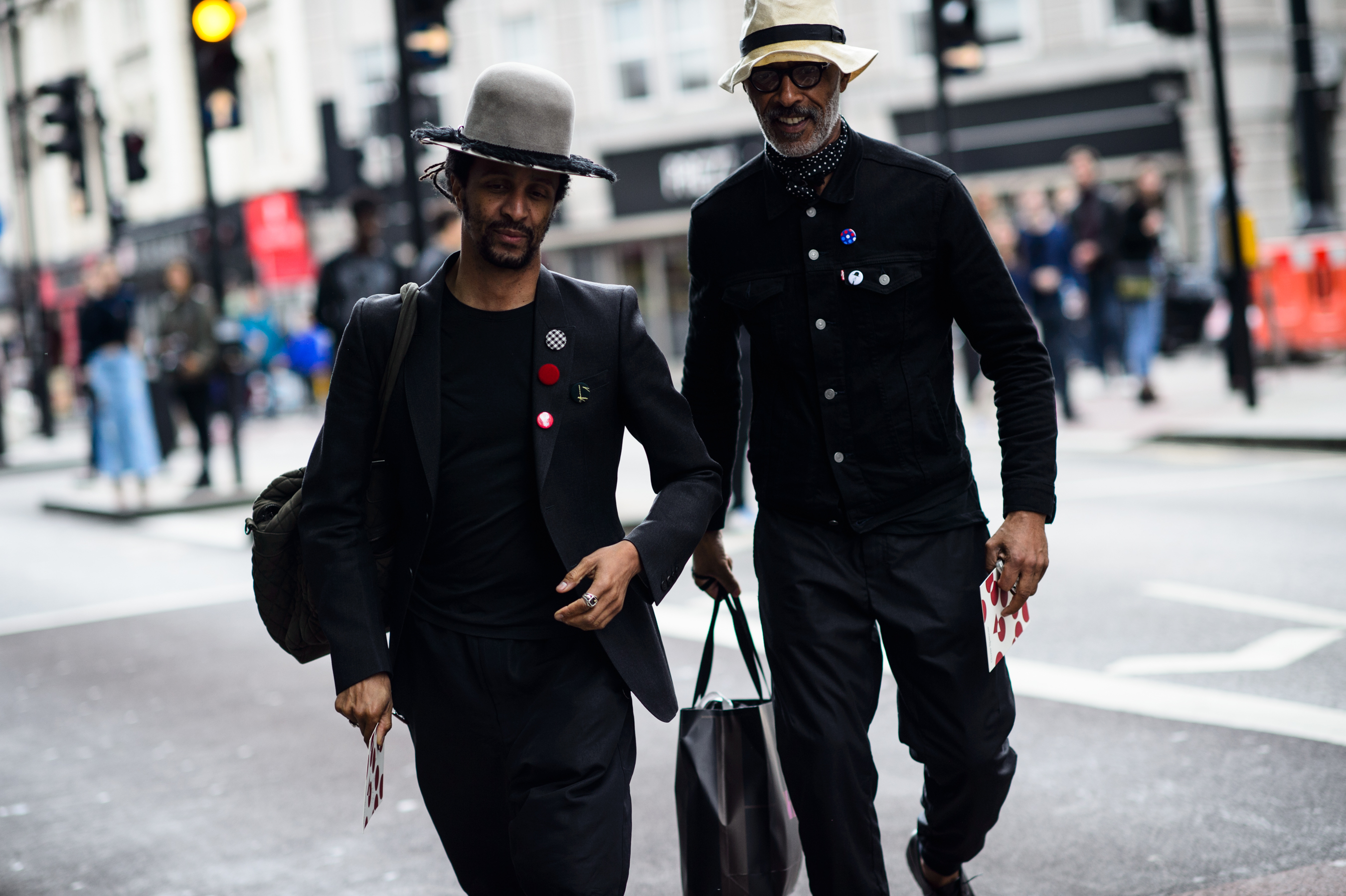 Two men wearing hats and pins
