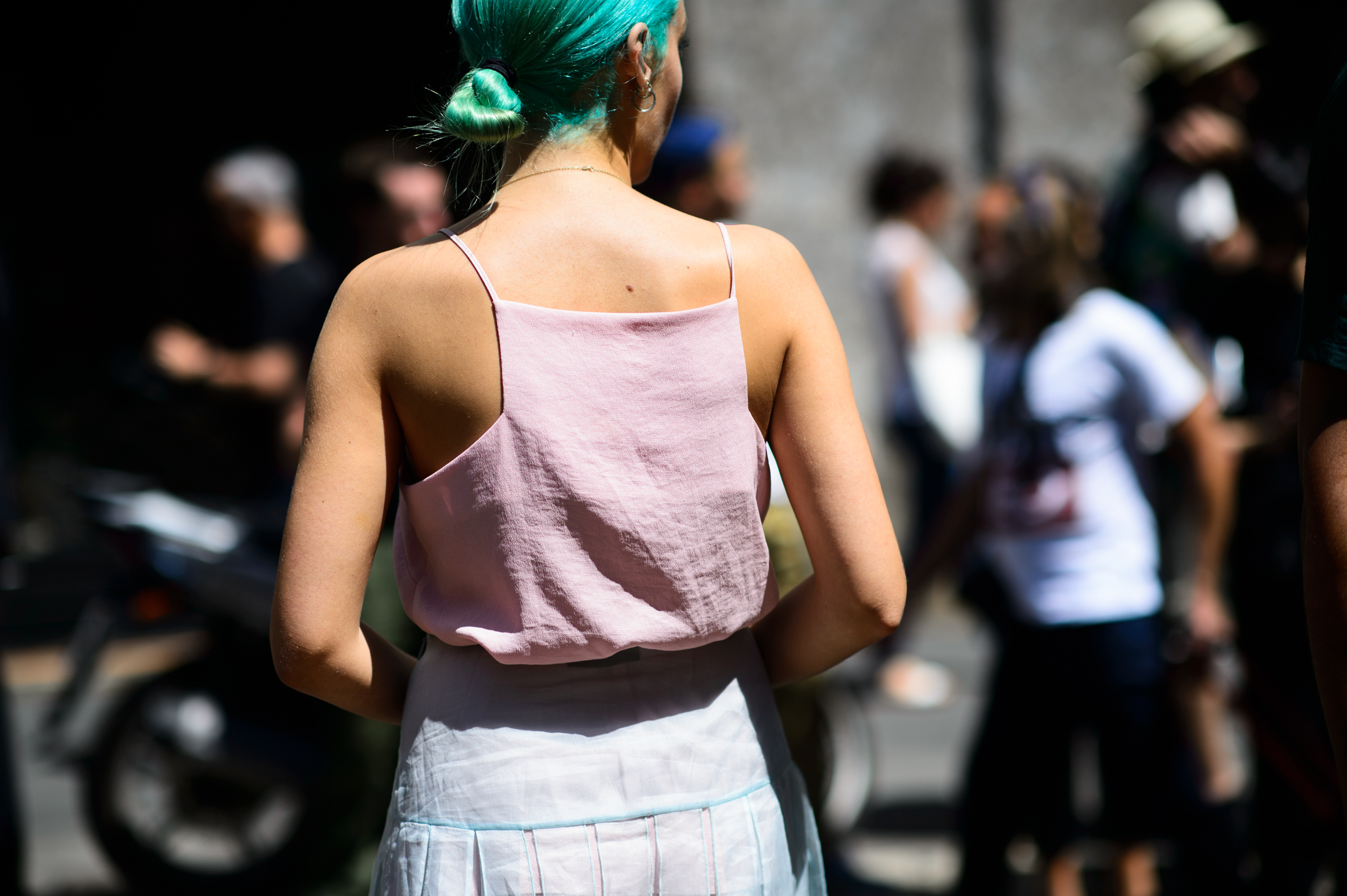 British editor with green hair in a pink top