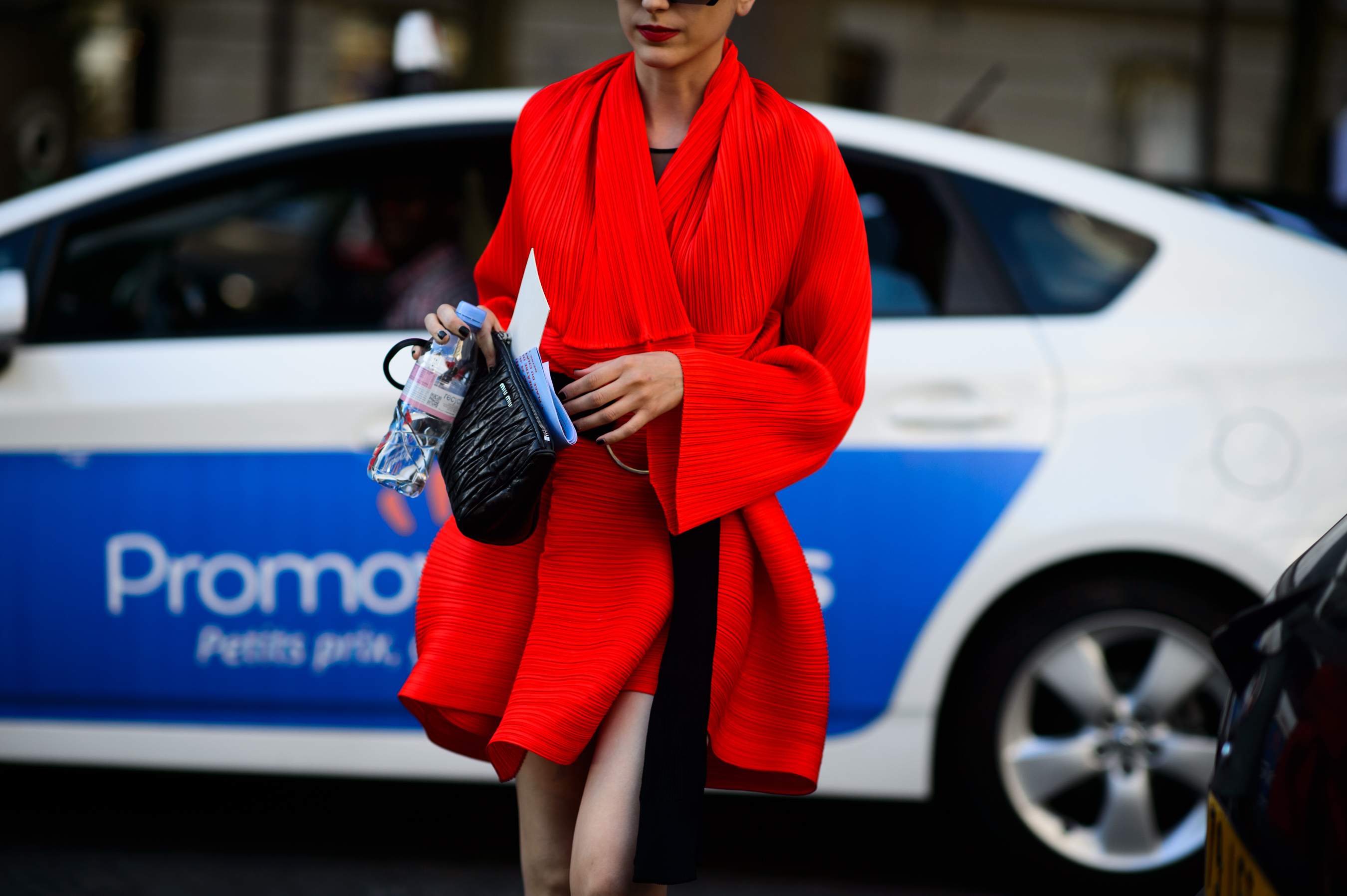 Woman wearing red Issey Miyake