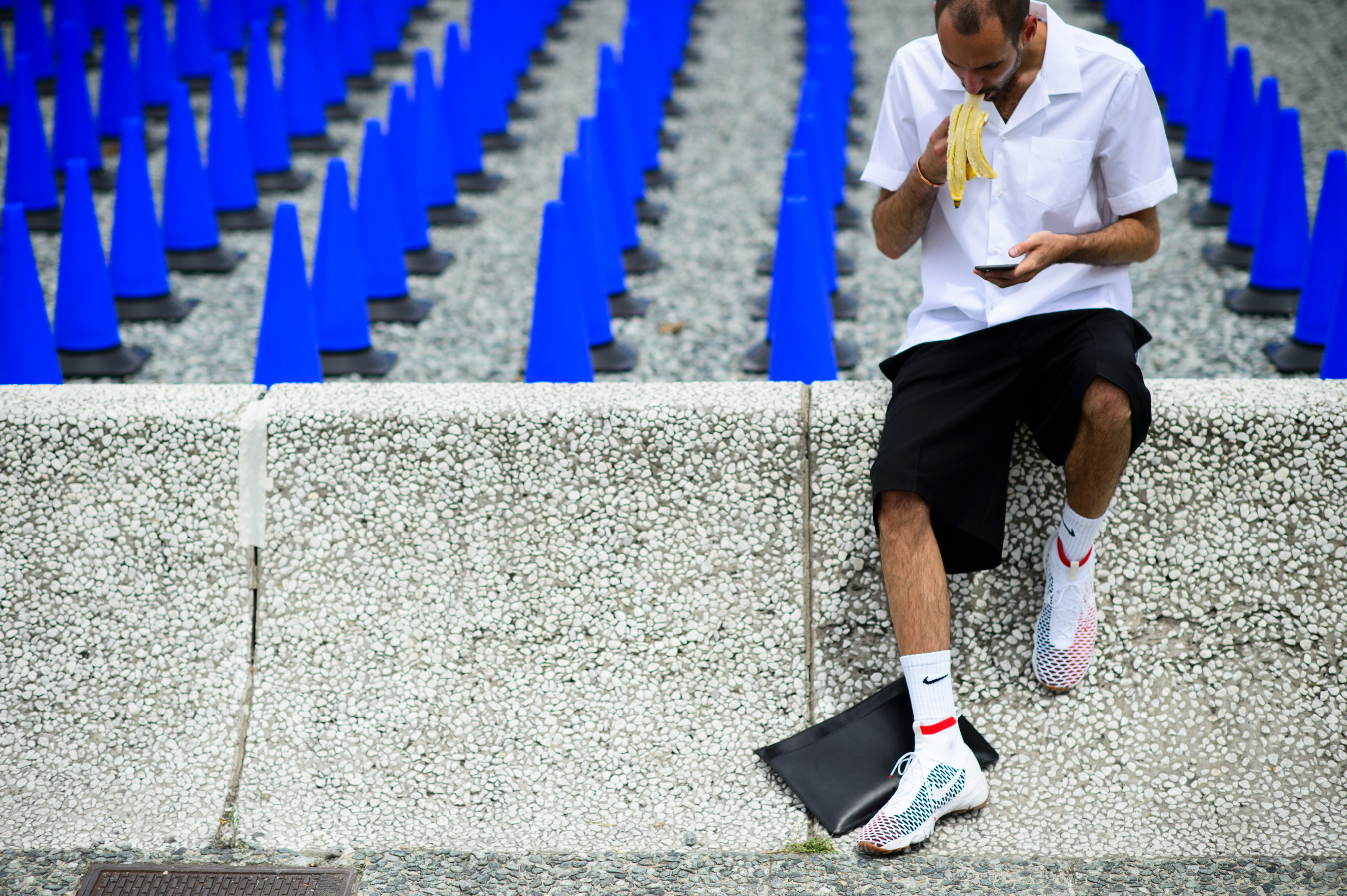 Man eating a banana at Pitti Uomo 88
