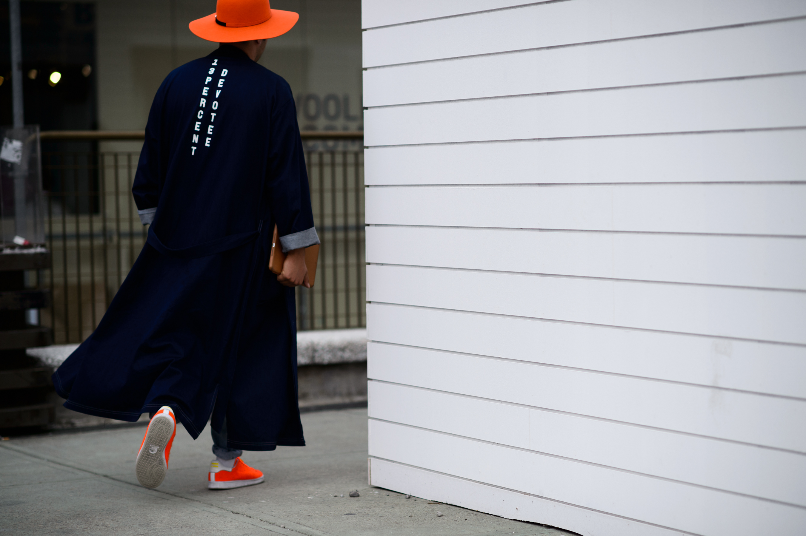 Man wearing an orange hat at Pitti Uomo