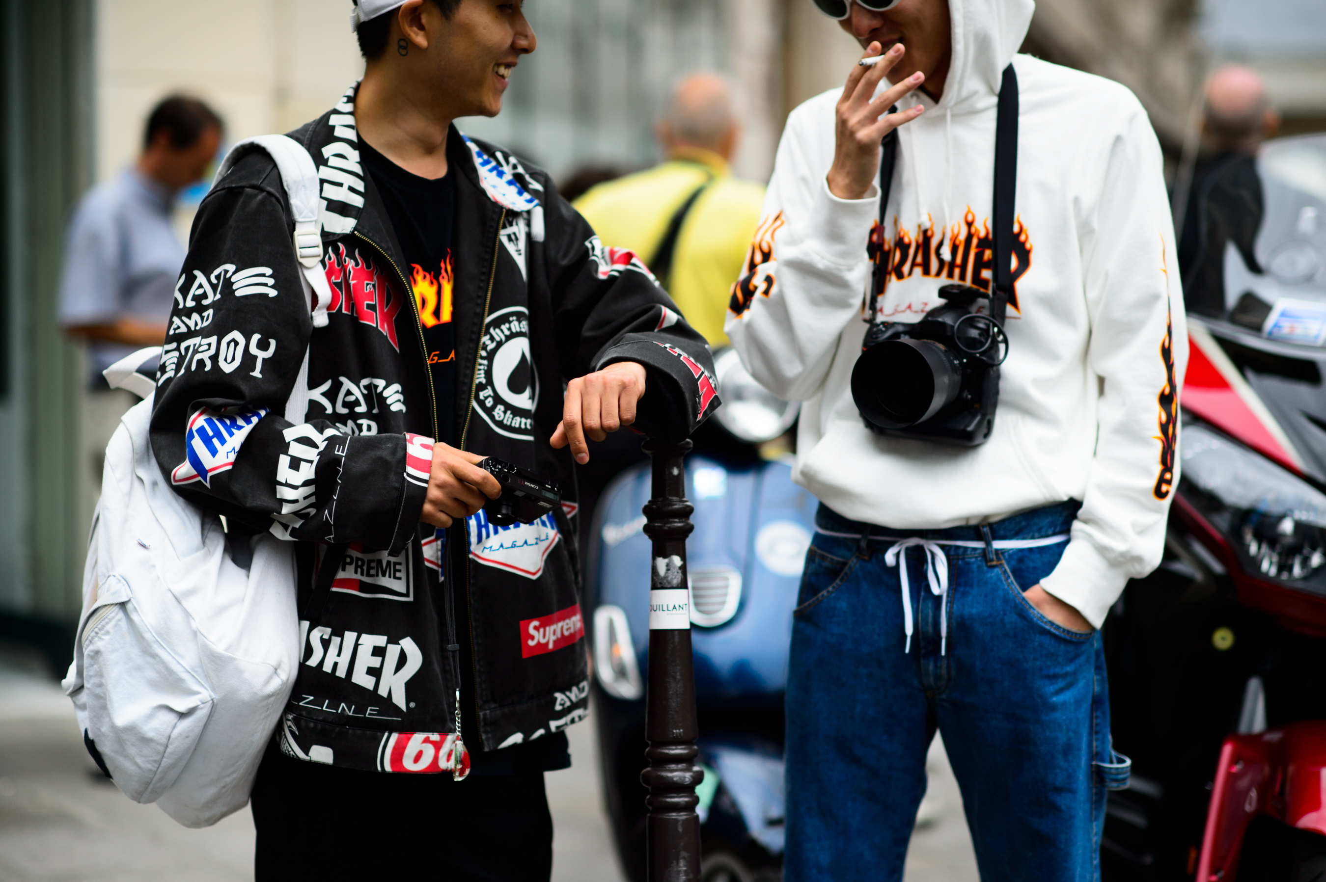 Two Korean men wearing Thrasher shirts