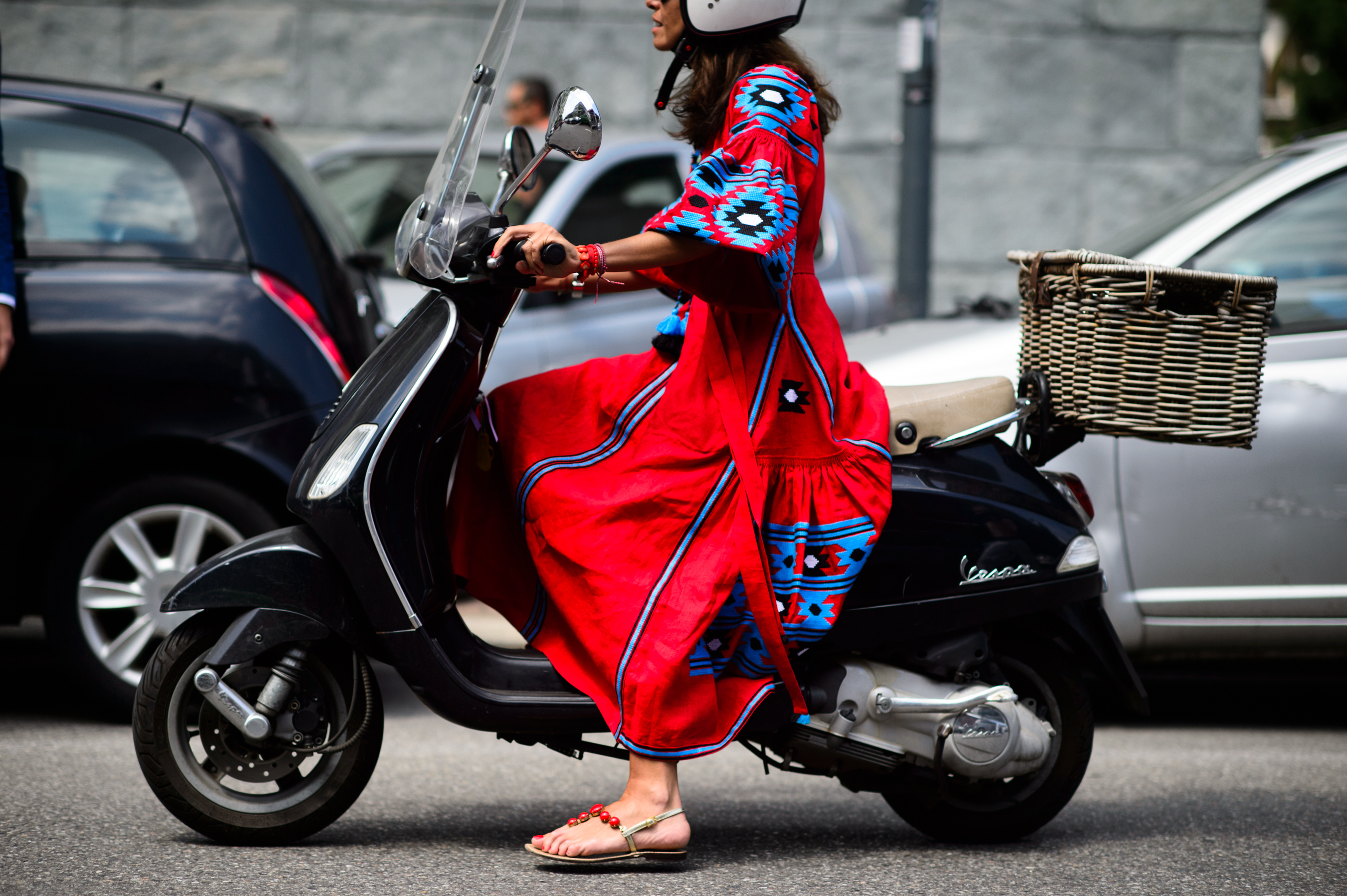 Italian woman on her Vespa in a red dress