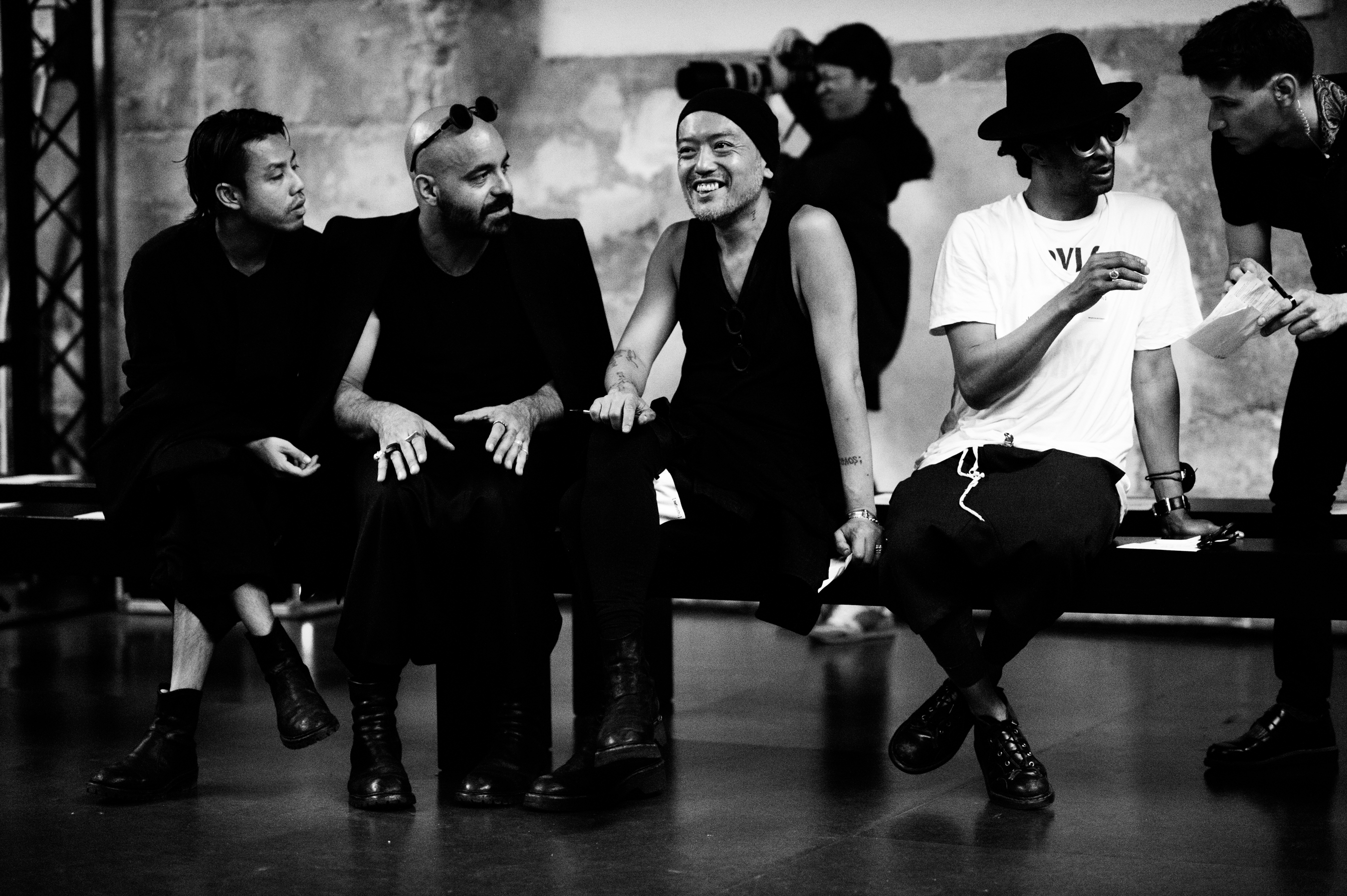 Designer and his team are watching the rehearsal of the menswear fashion show
