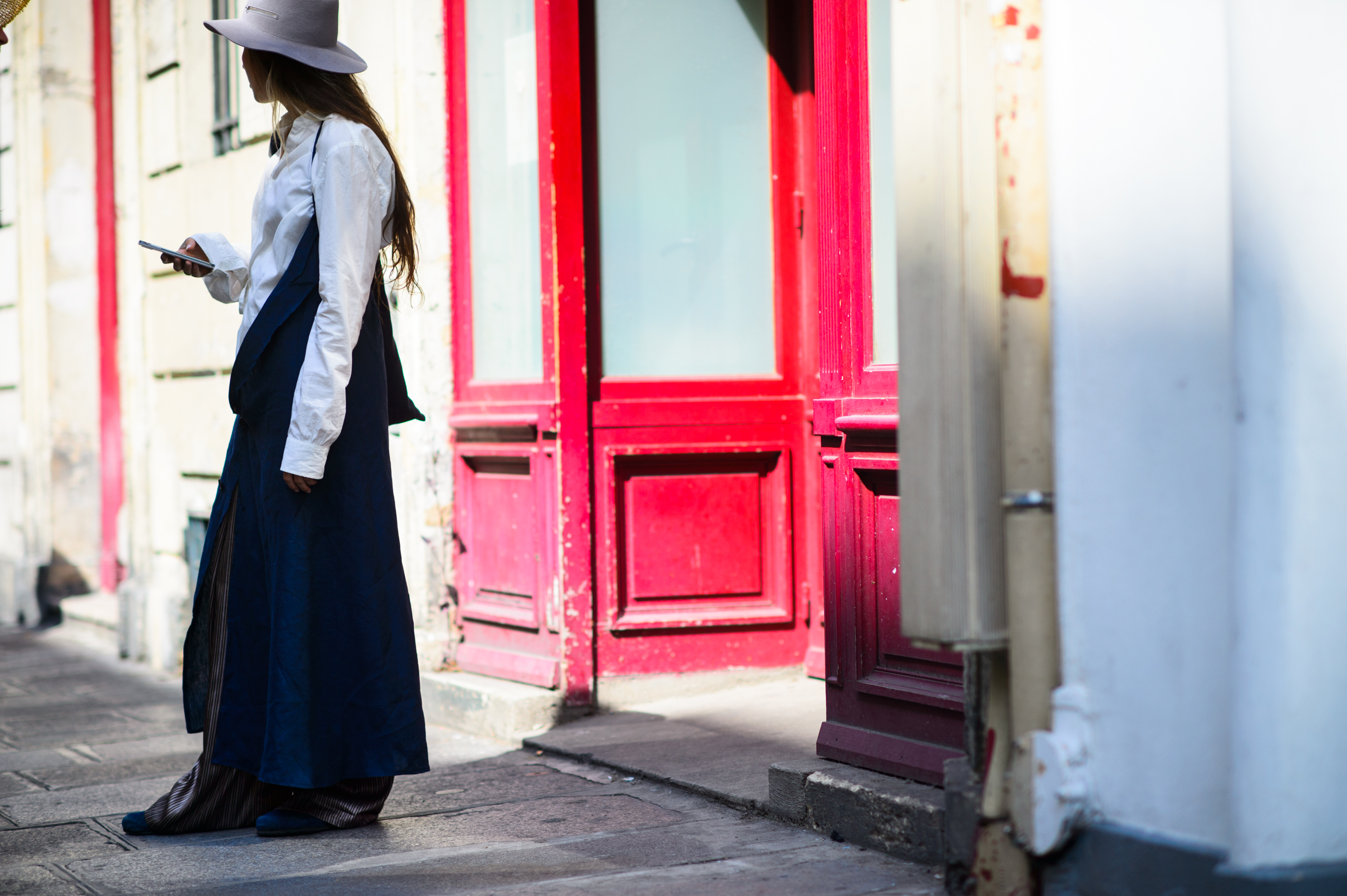 Young female in DIY clothes and Larose hat before Gosha Rubchinskiy show