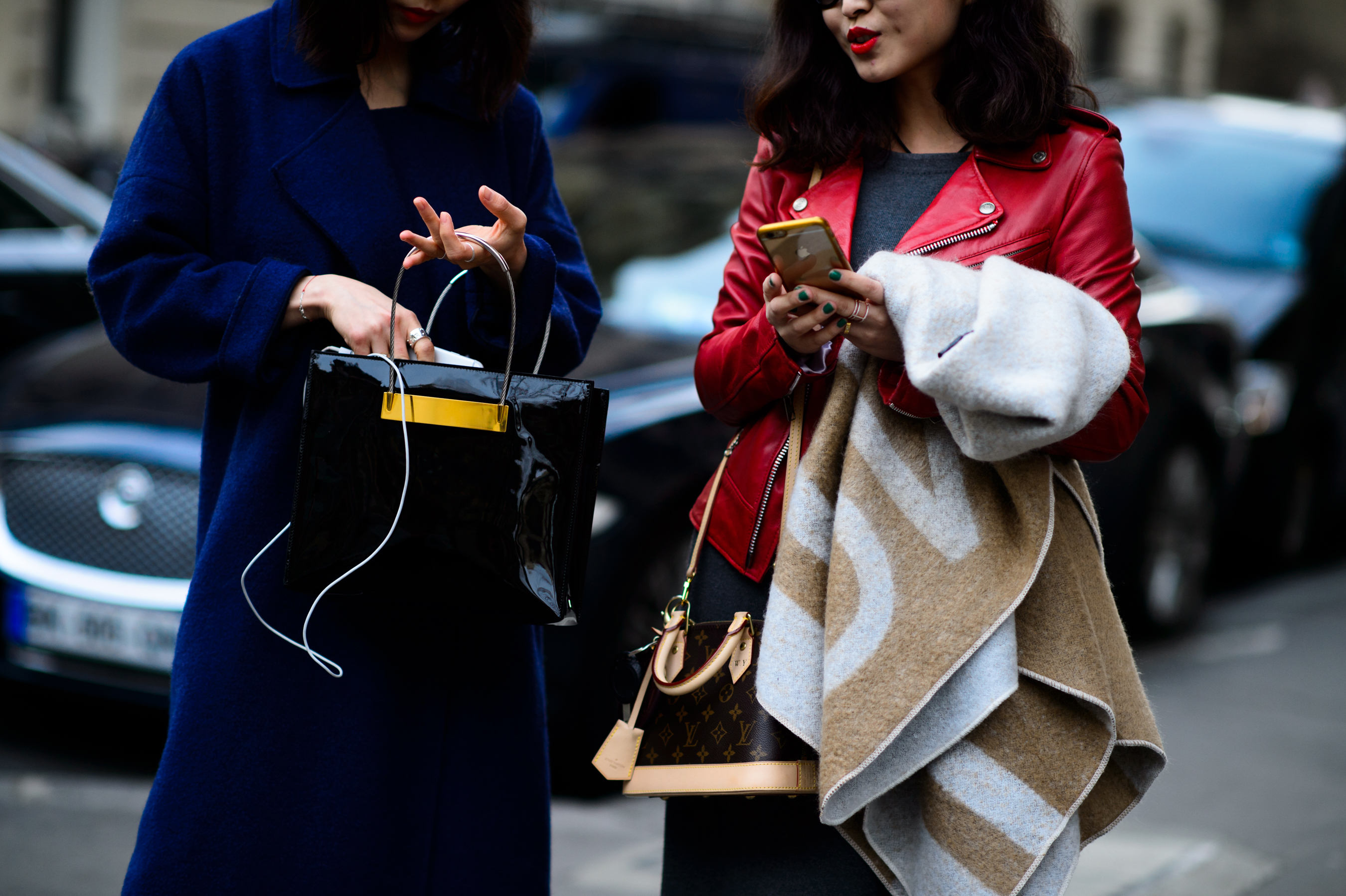 Two women in blue coat and red leather jacket before the show