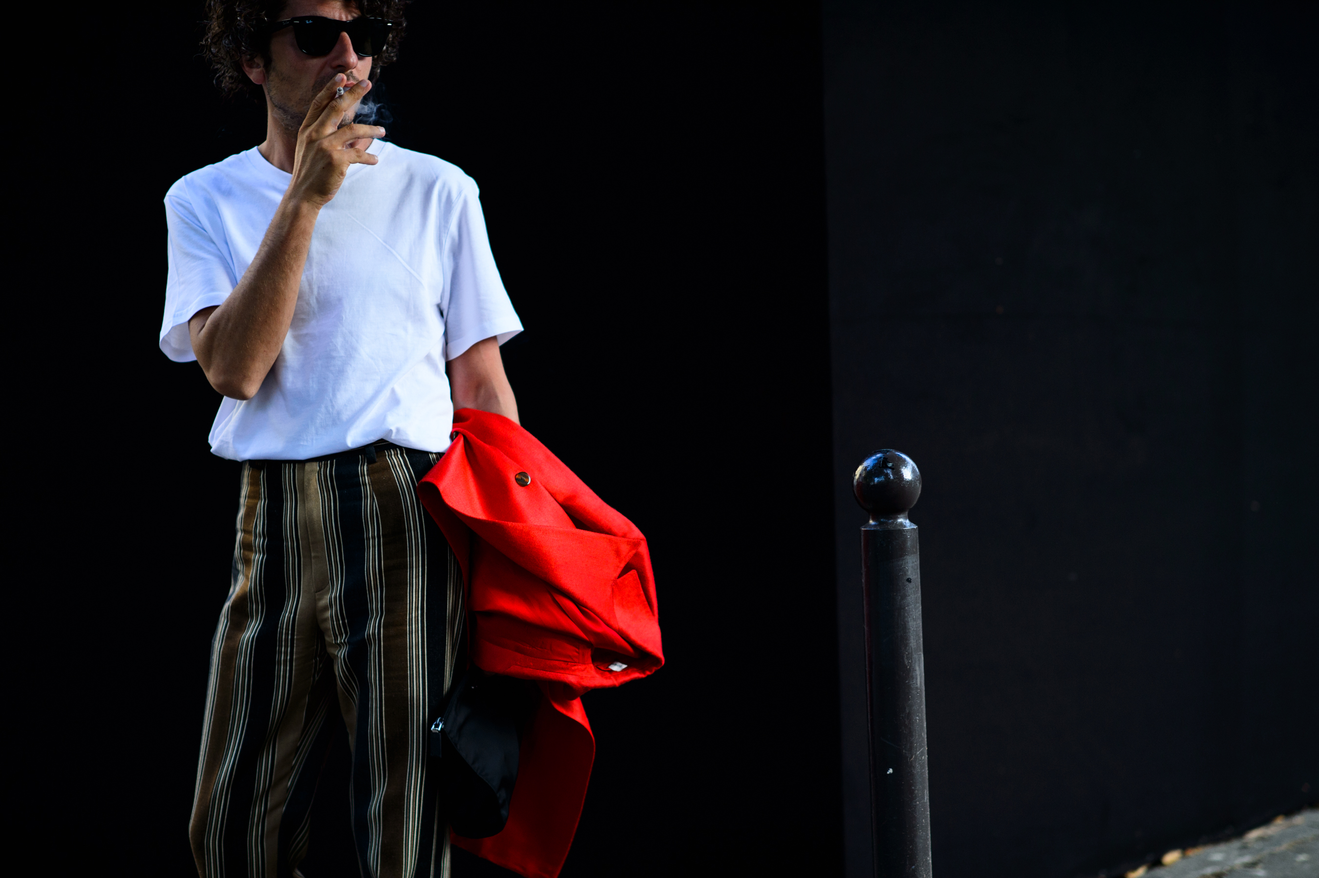 A man with red jacket smoking before the show