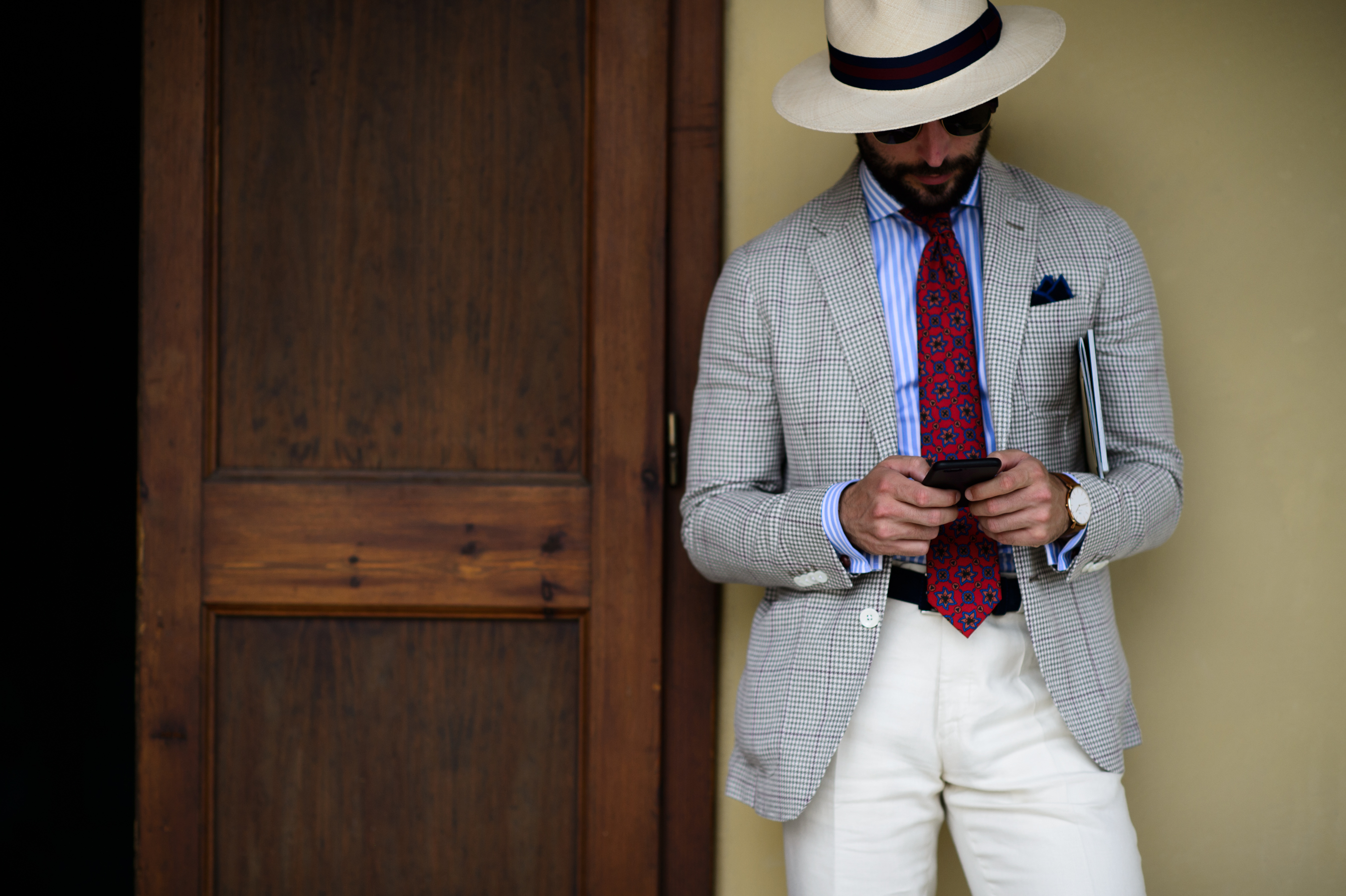 A man in a suit and light hat in Italy