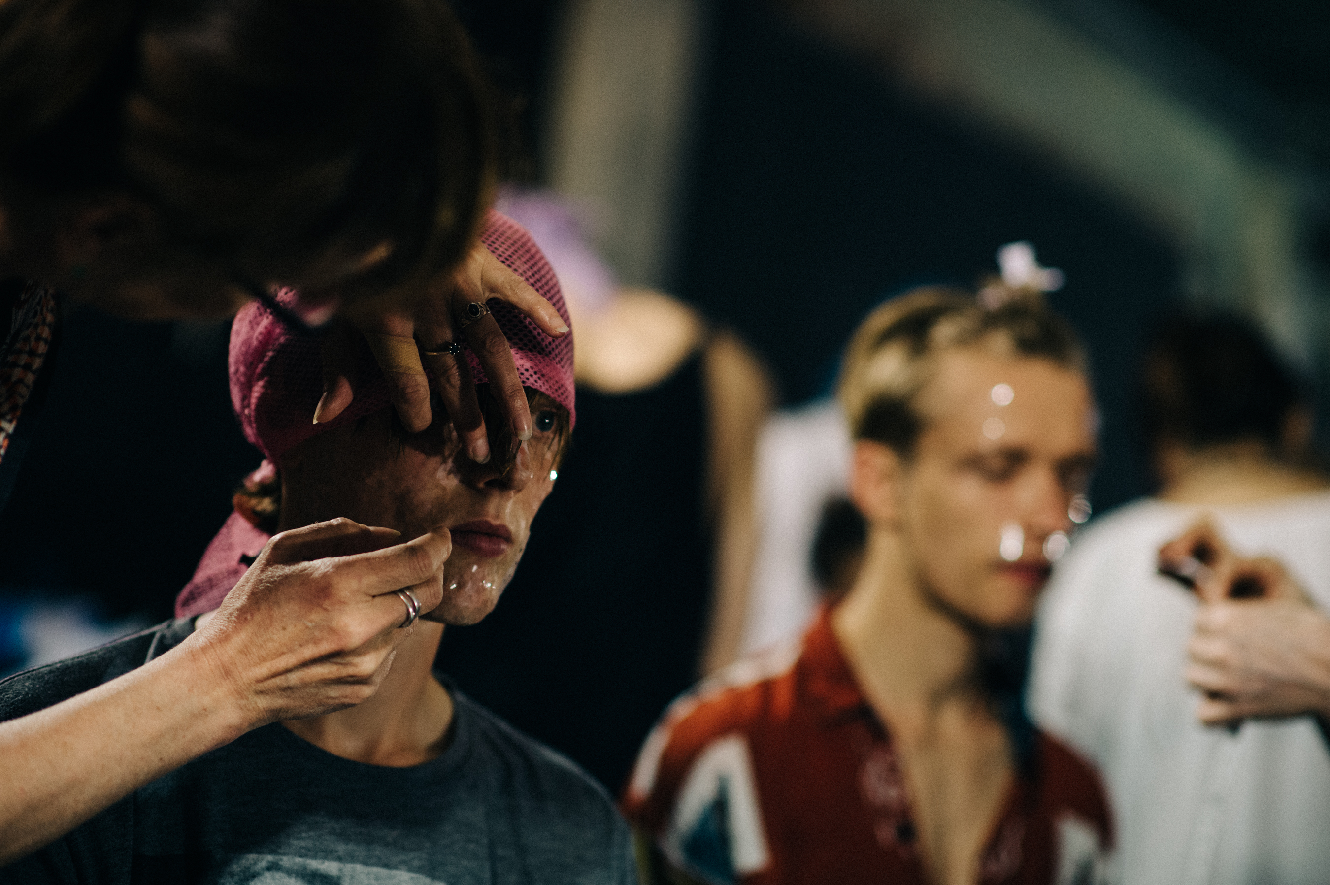 Male model Ned Barton getting hair and make up done before the show