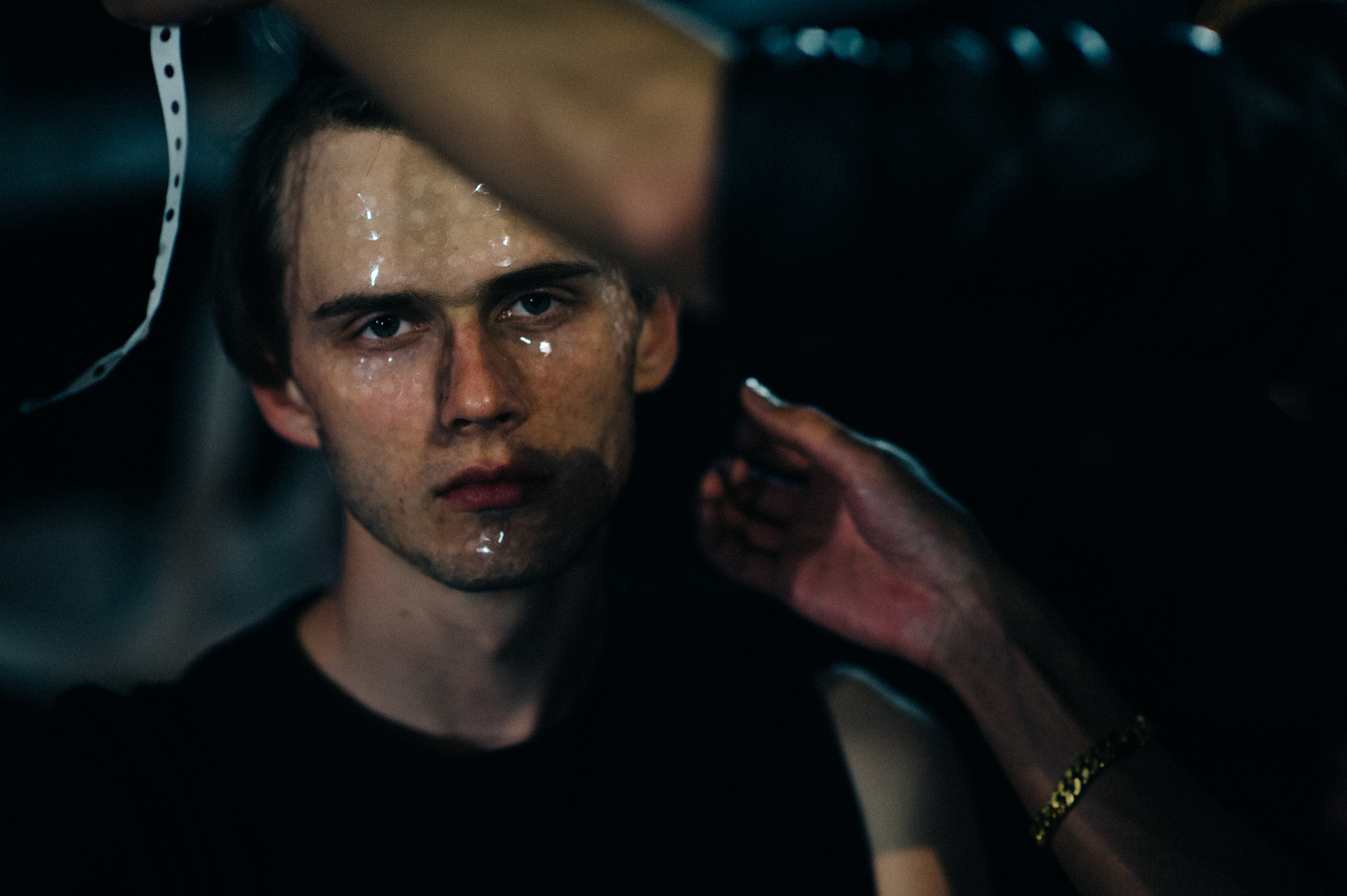 Male model getting conceptual make up done before the show