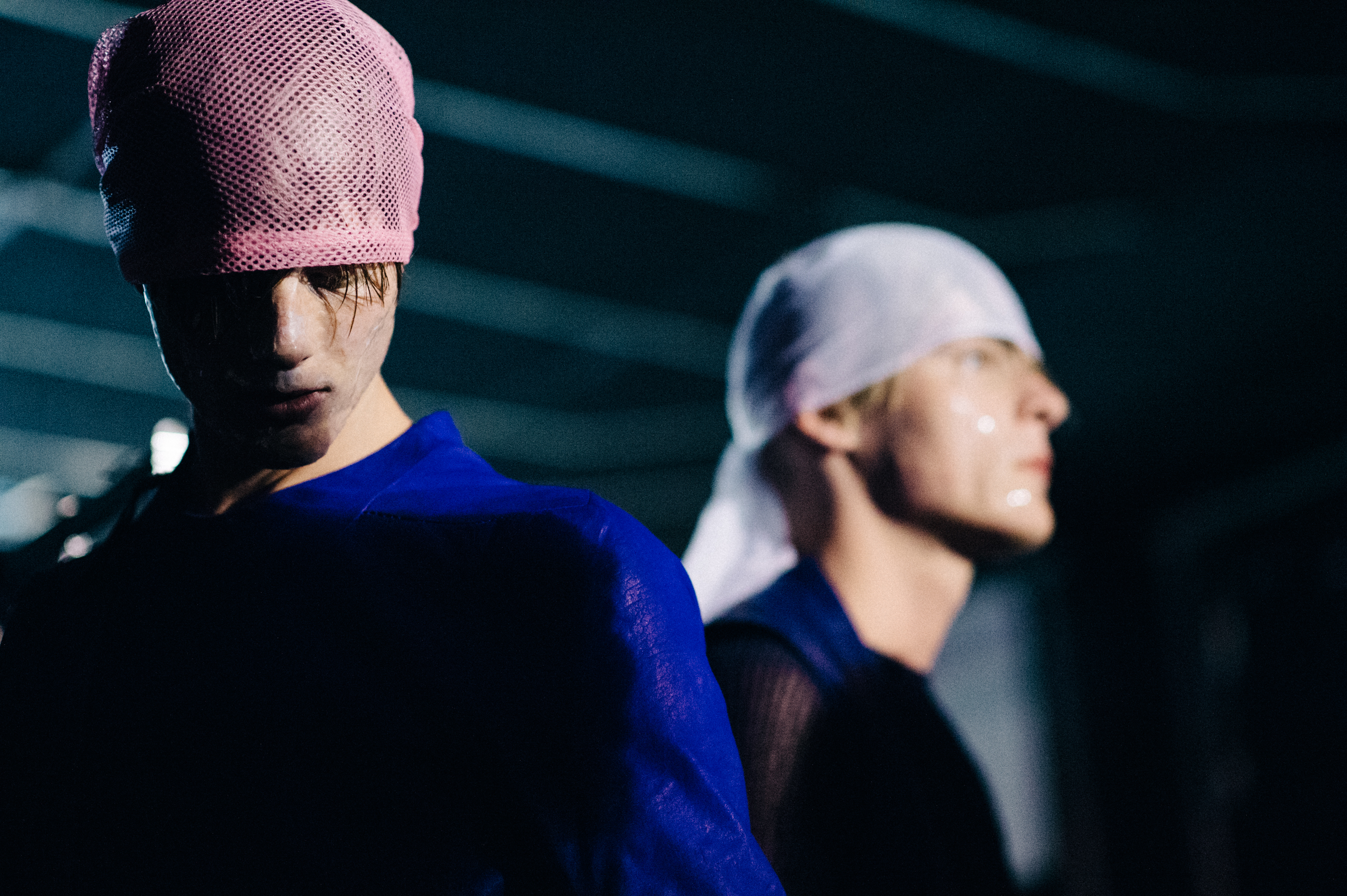 Two male models dressed before the show