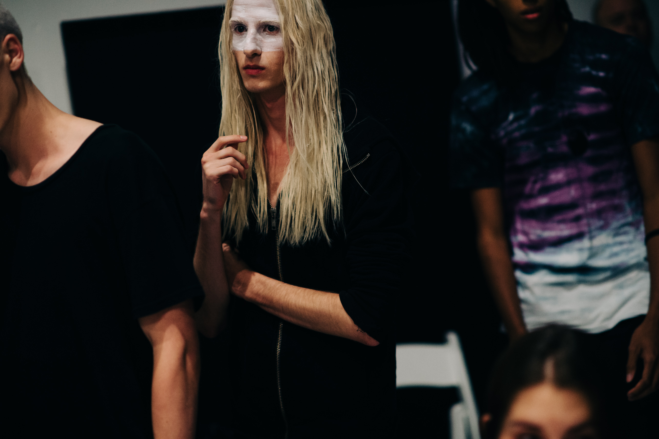 Male model with long white hair before the show