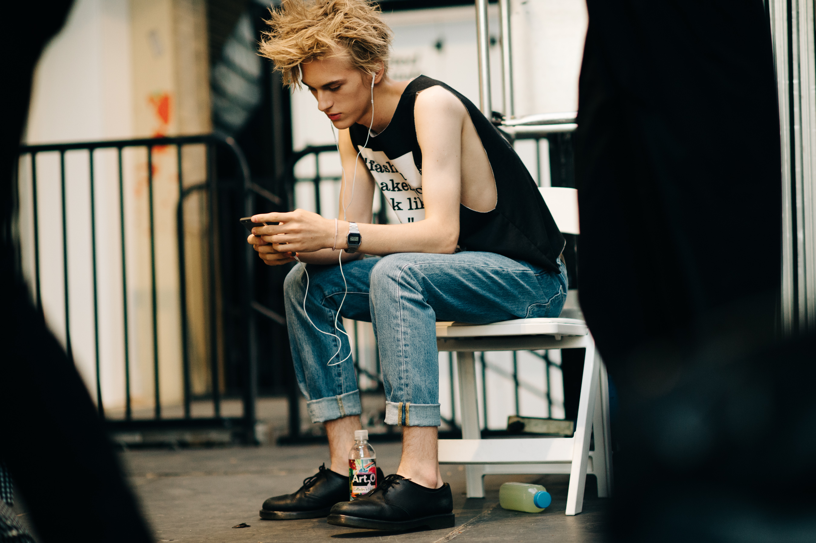 Male model sitting before the show