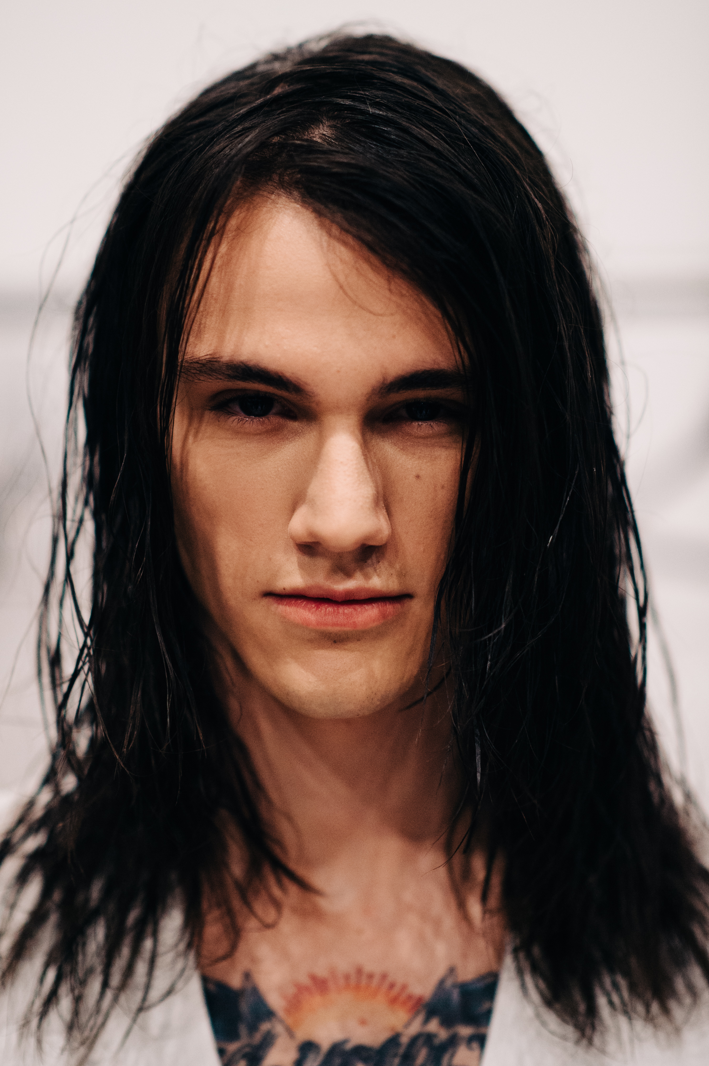 Portrait of male model with long hair before the show