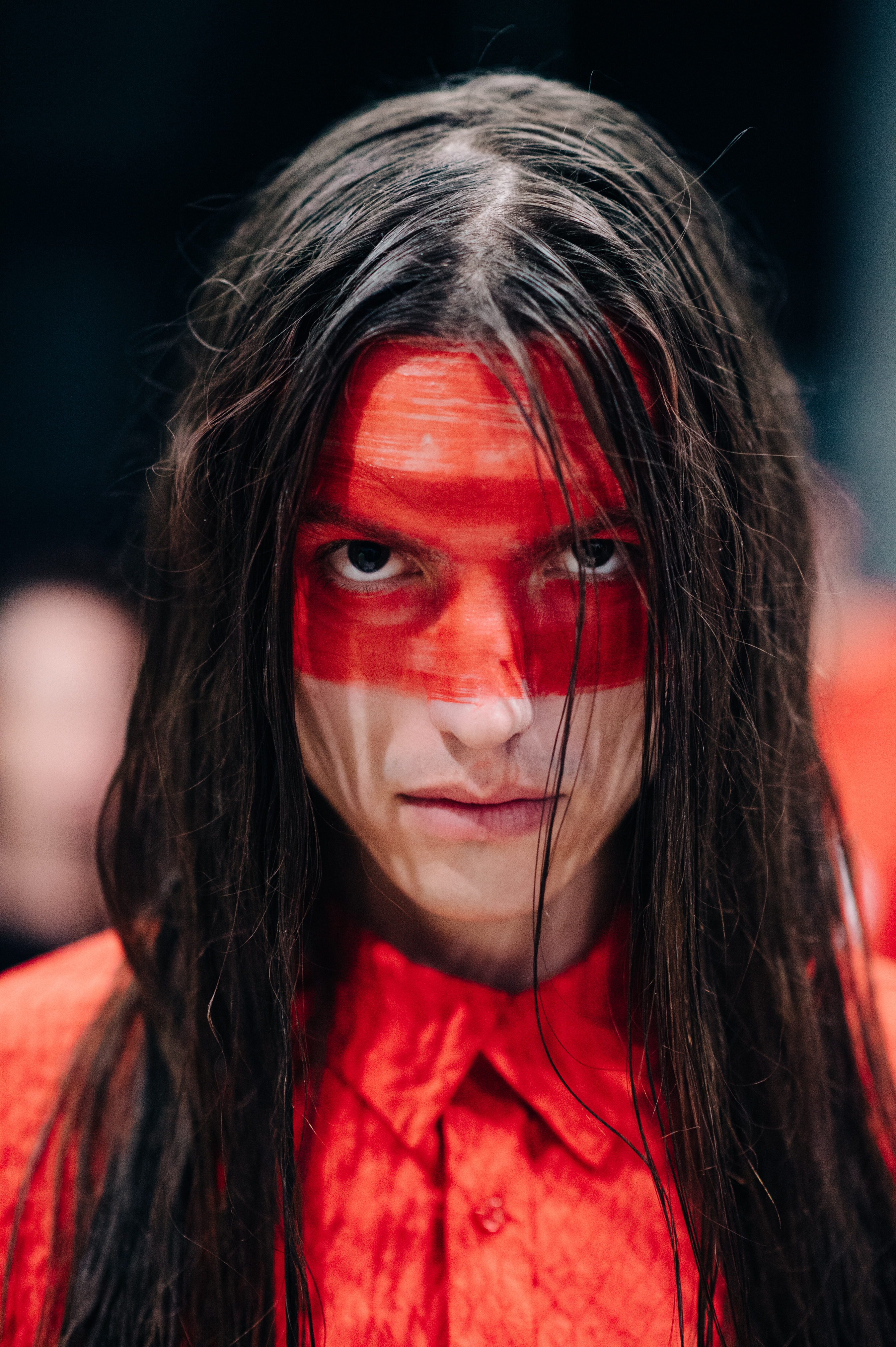 Portrait of male model wearing red make up