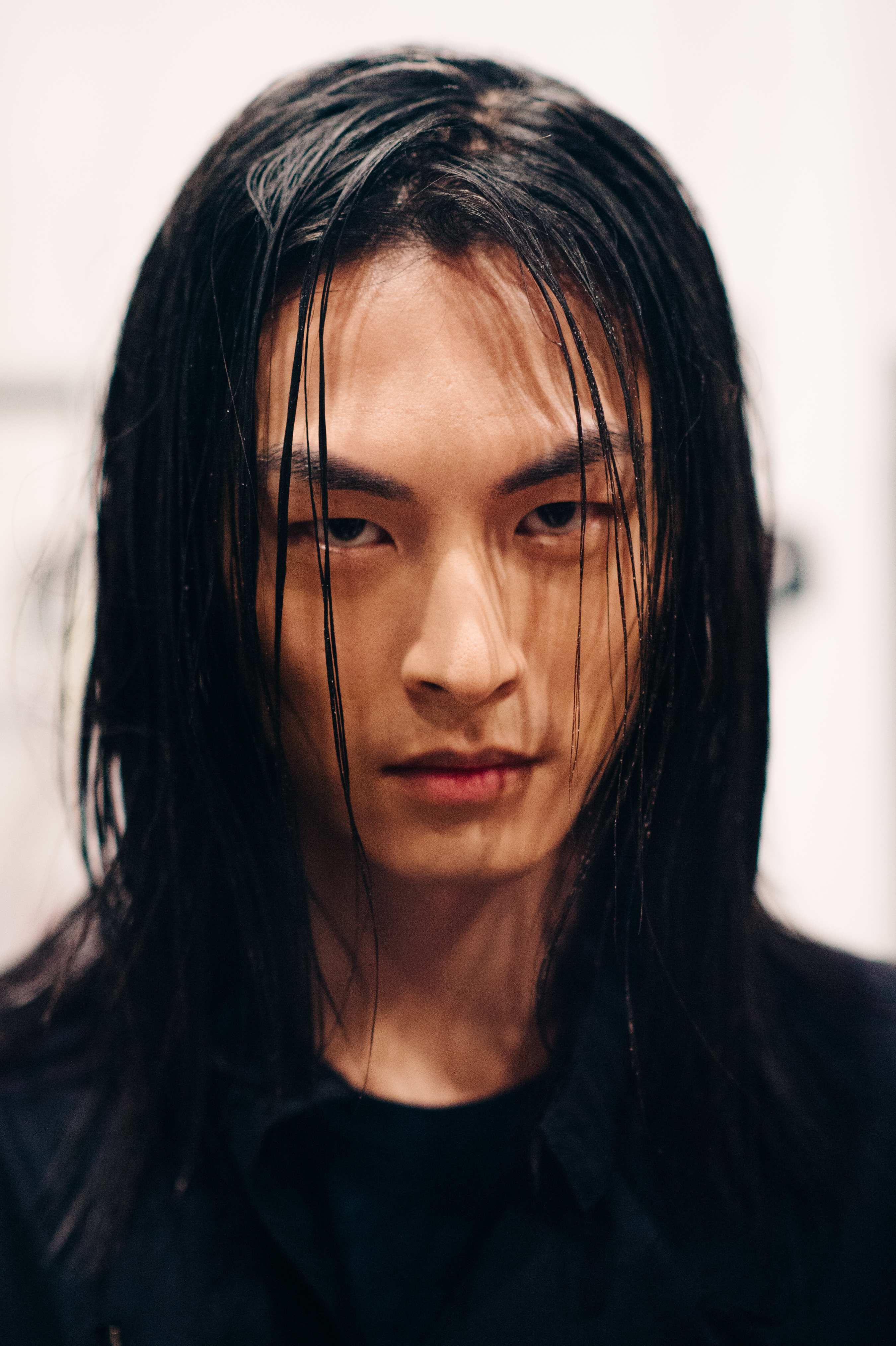 Portrait of male model with long black hair