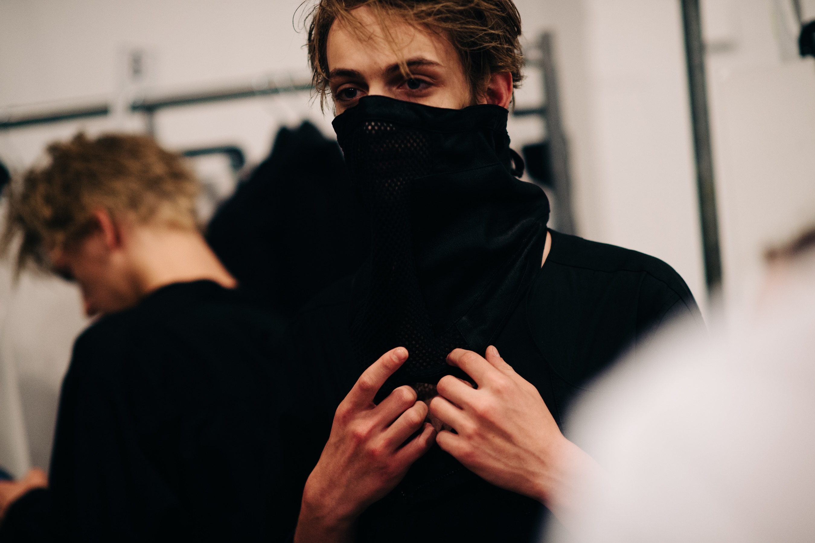 Male model getting dressed before the show