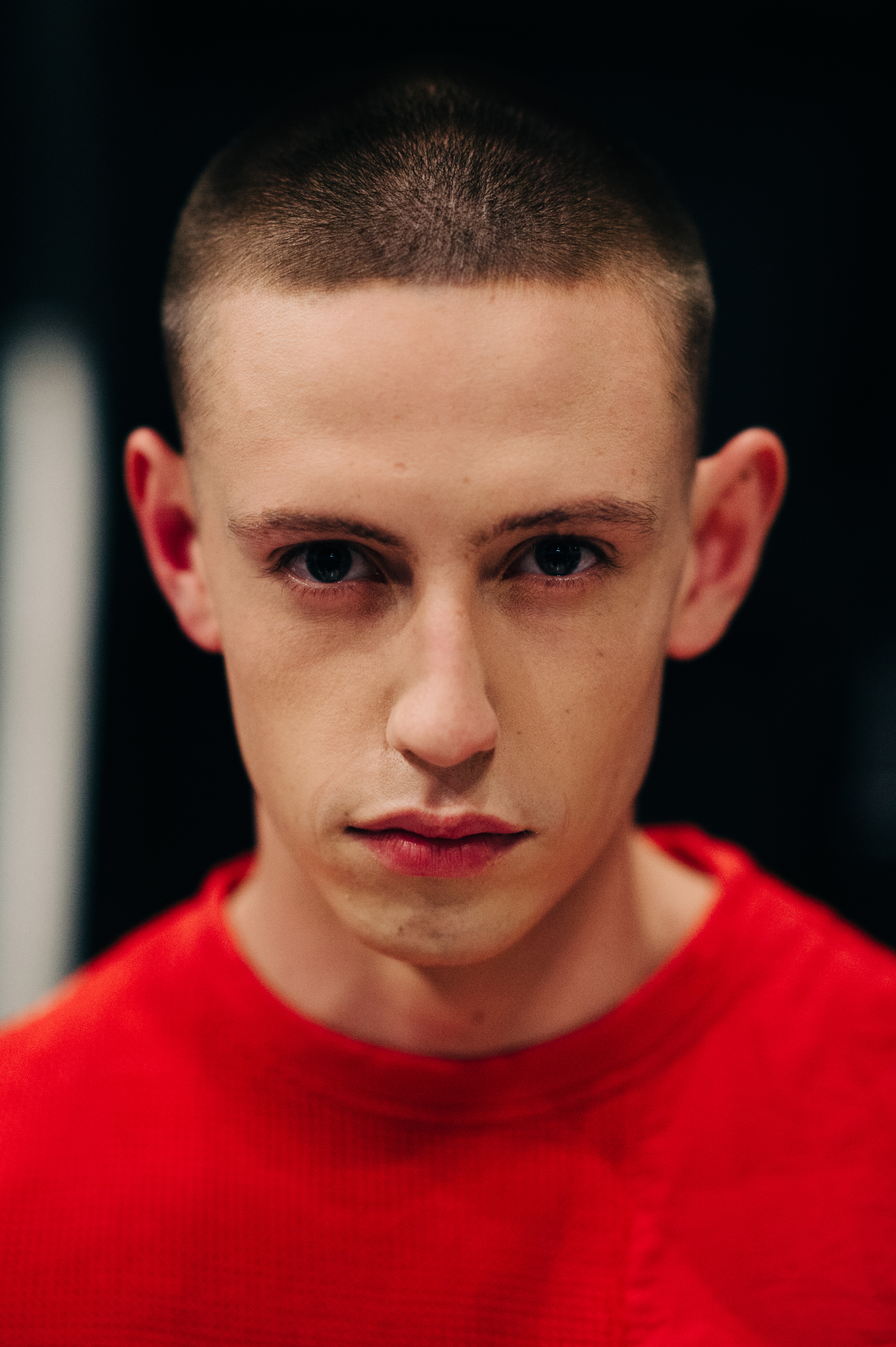 Portrait of male model with short hair in red outfit