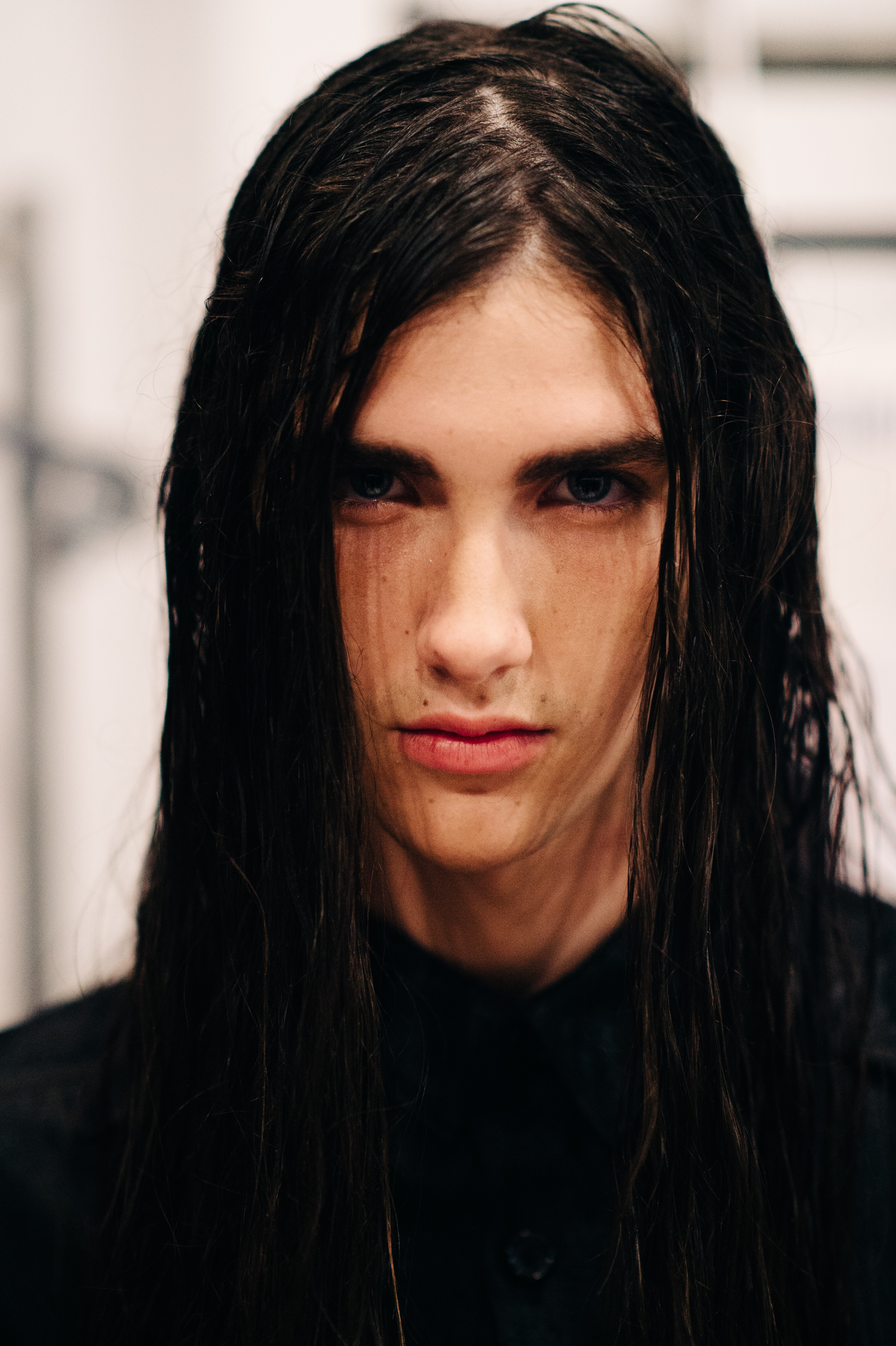 Portrait of male model with long black hair