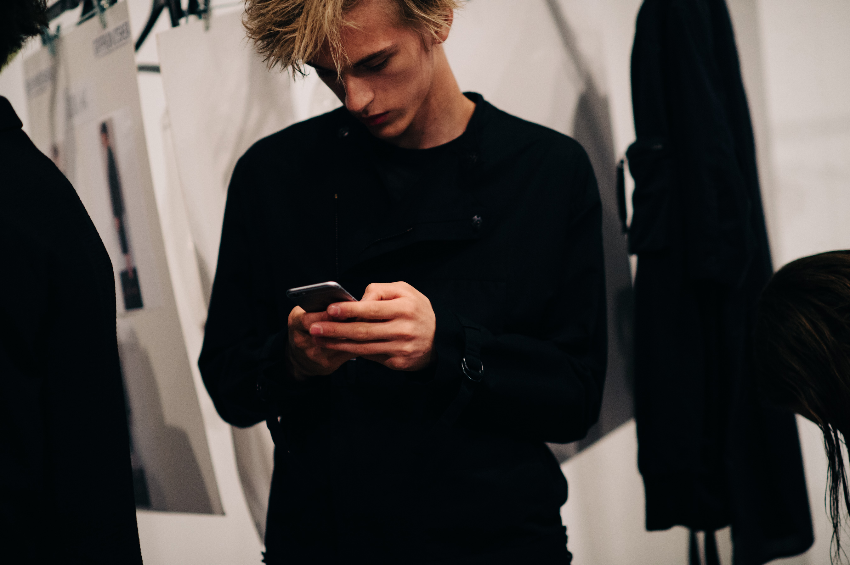 Male model on a phone before the show