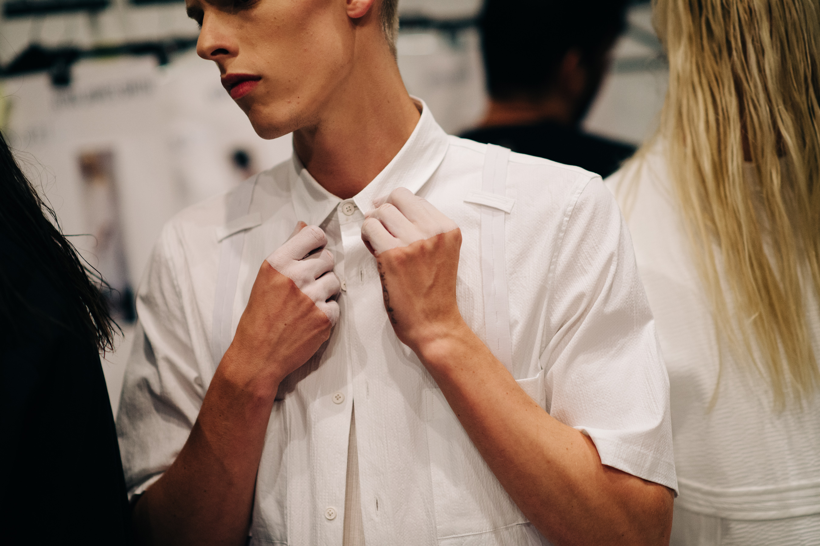 Male model with white paint on fingers