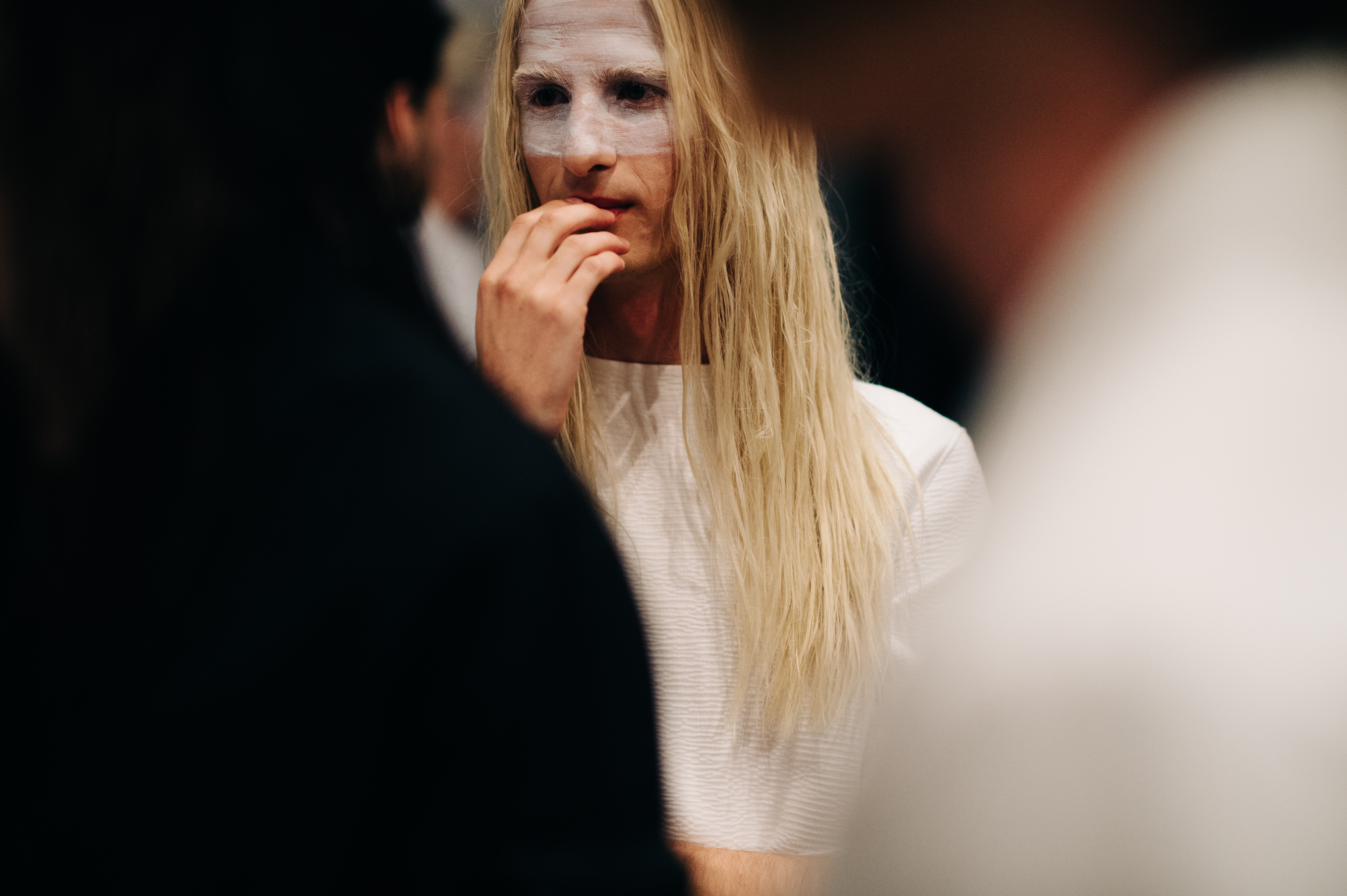 Male model with long white hair before the show