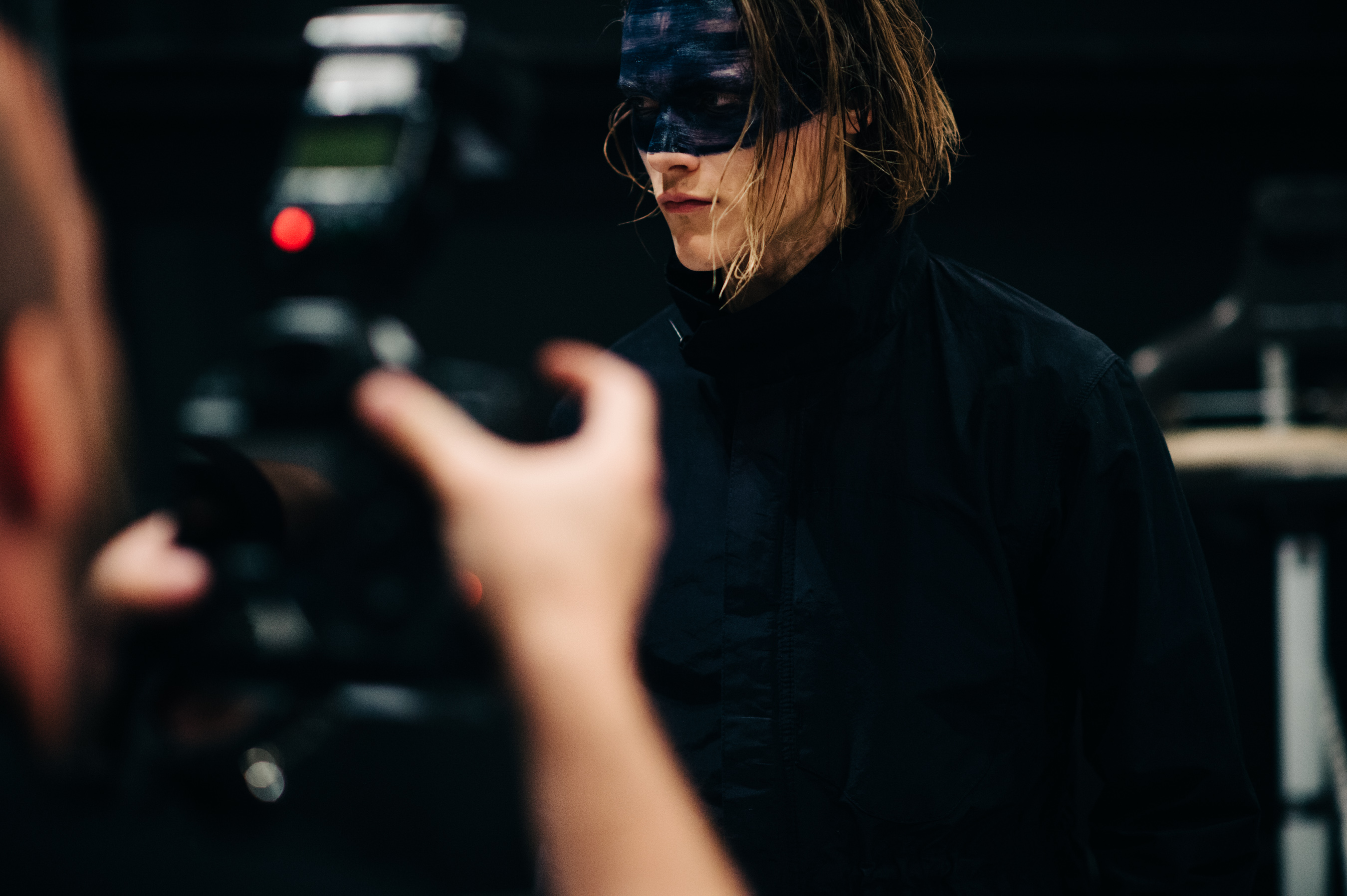 Male model with black make up before the show