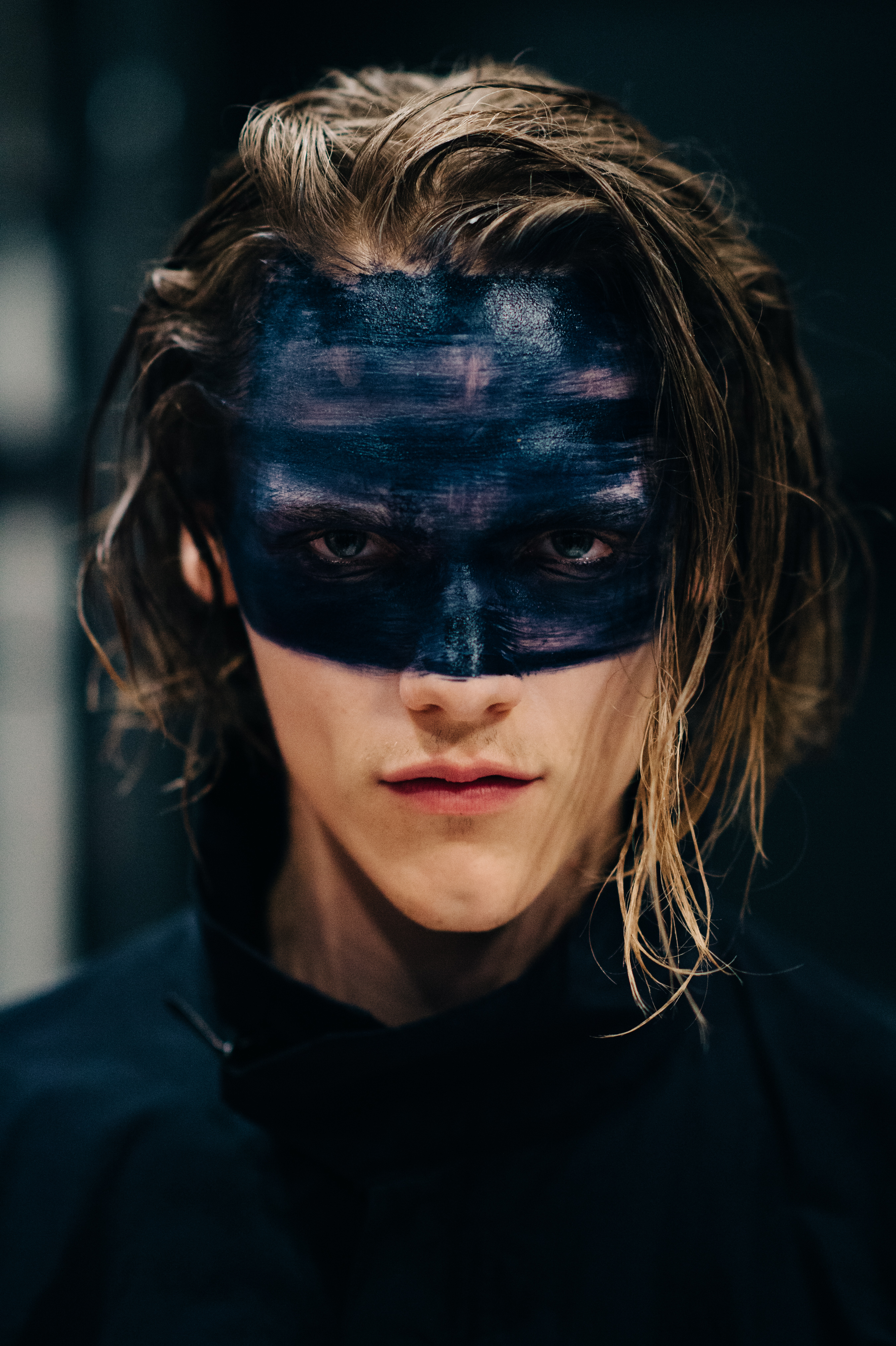 Portrait of male model wearing black make up
