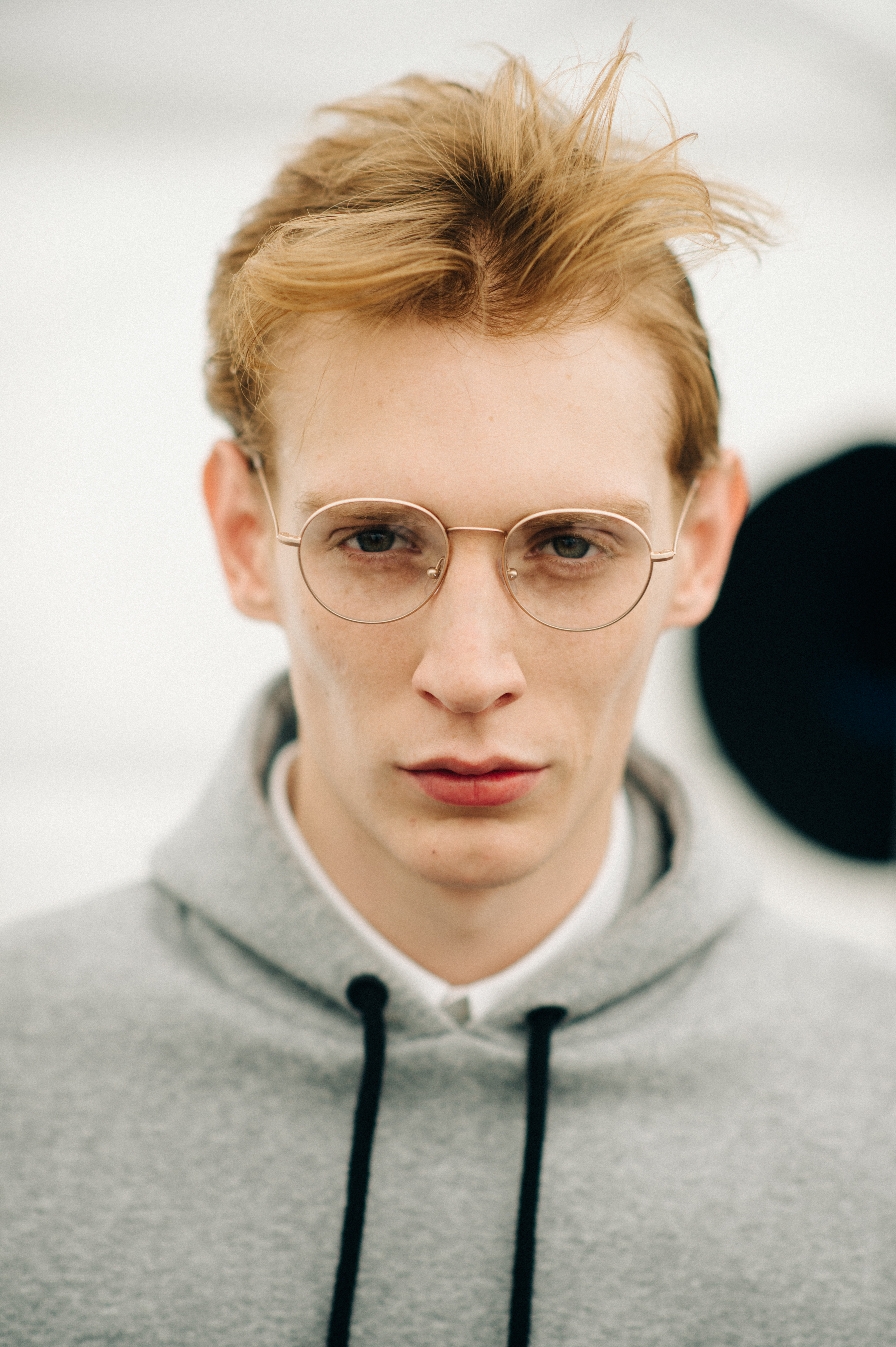 Male model with red hair and grey sweatshirt before the show