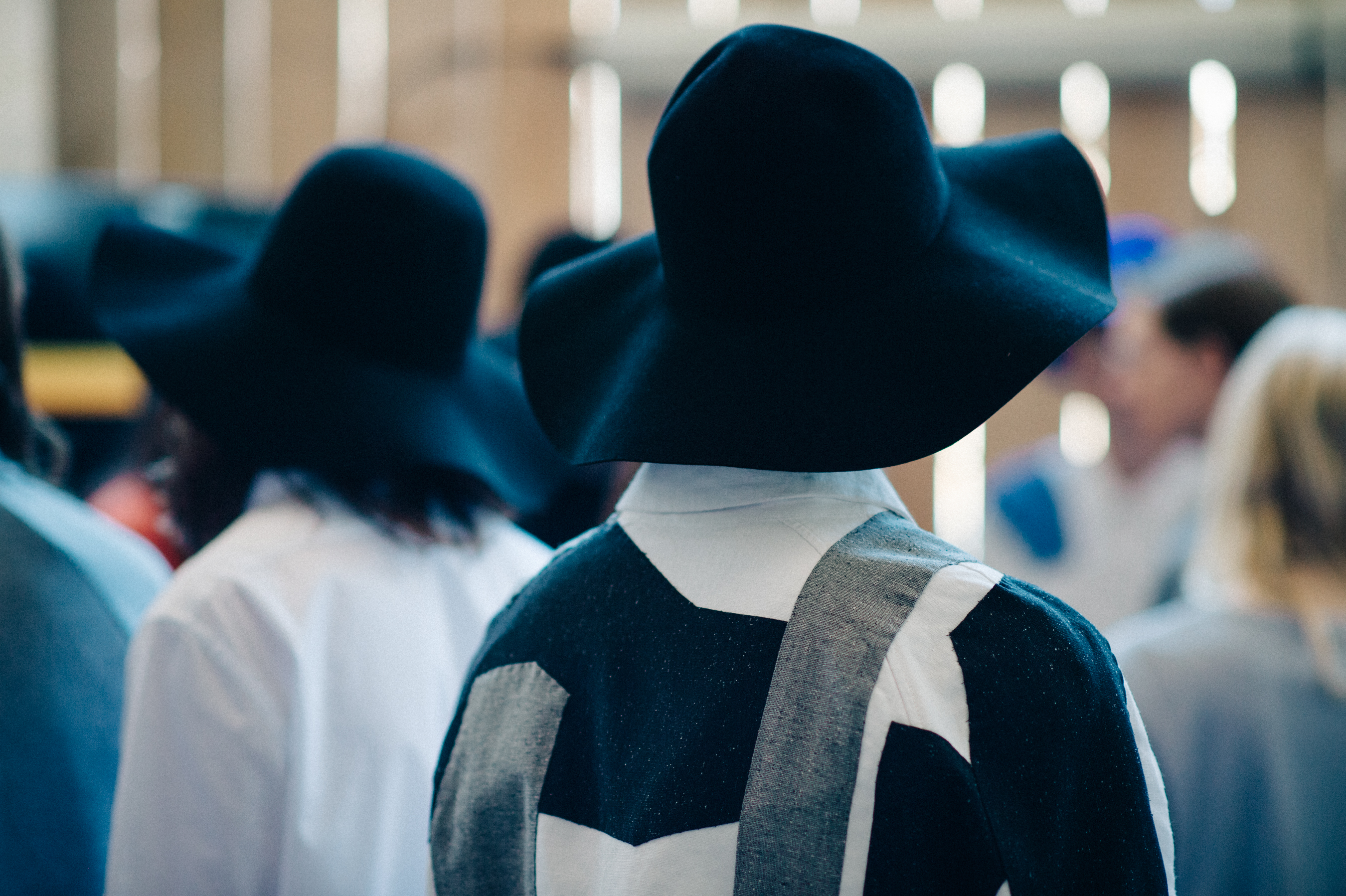 Male models wearing hats before the fashion show
