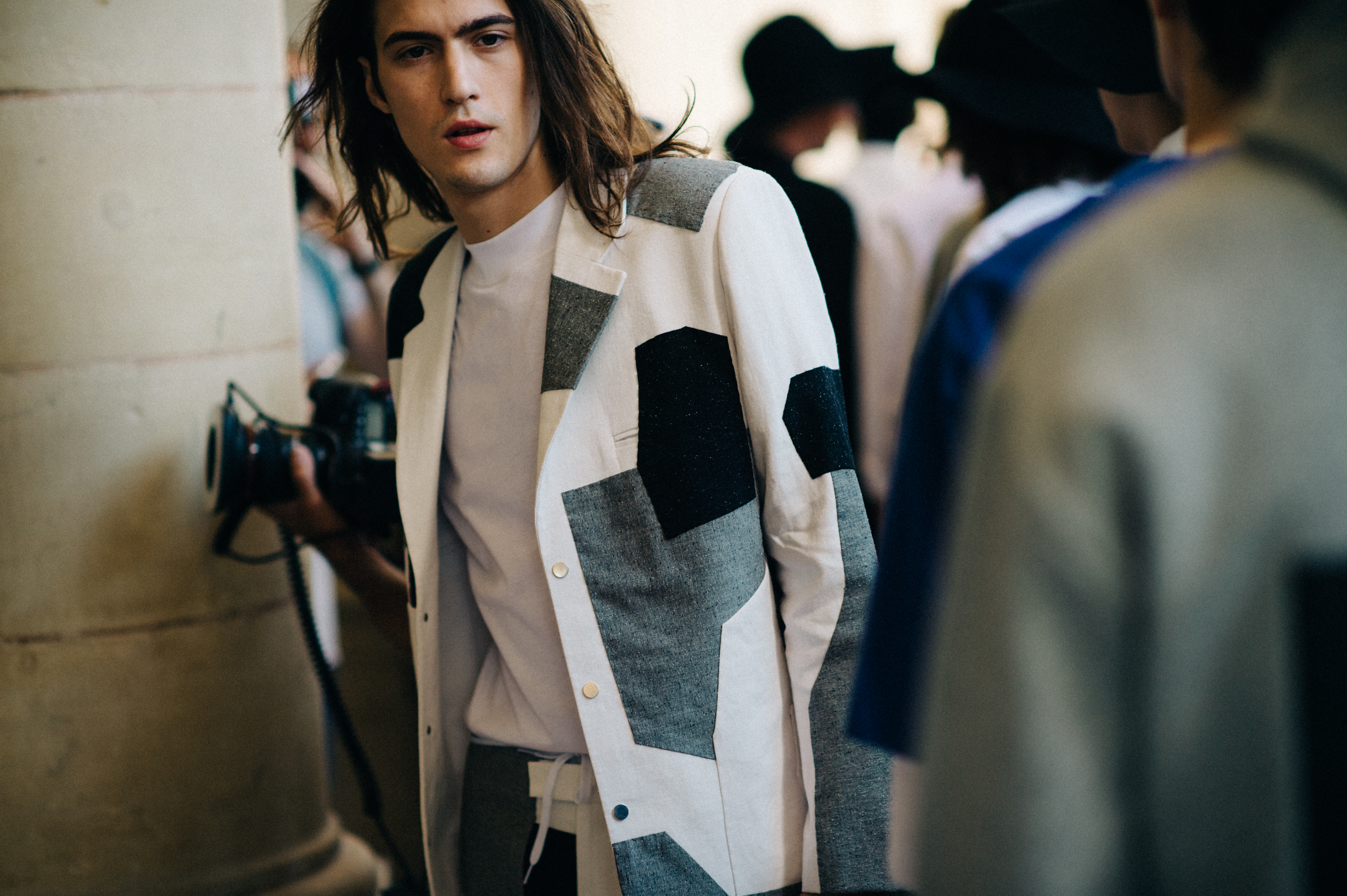 Male model in patch work jacket before the fashion show