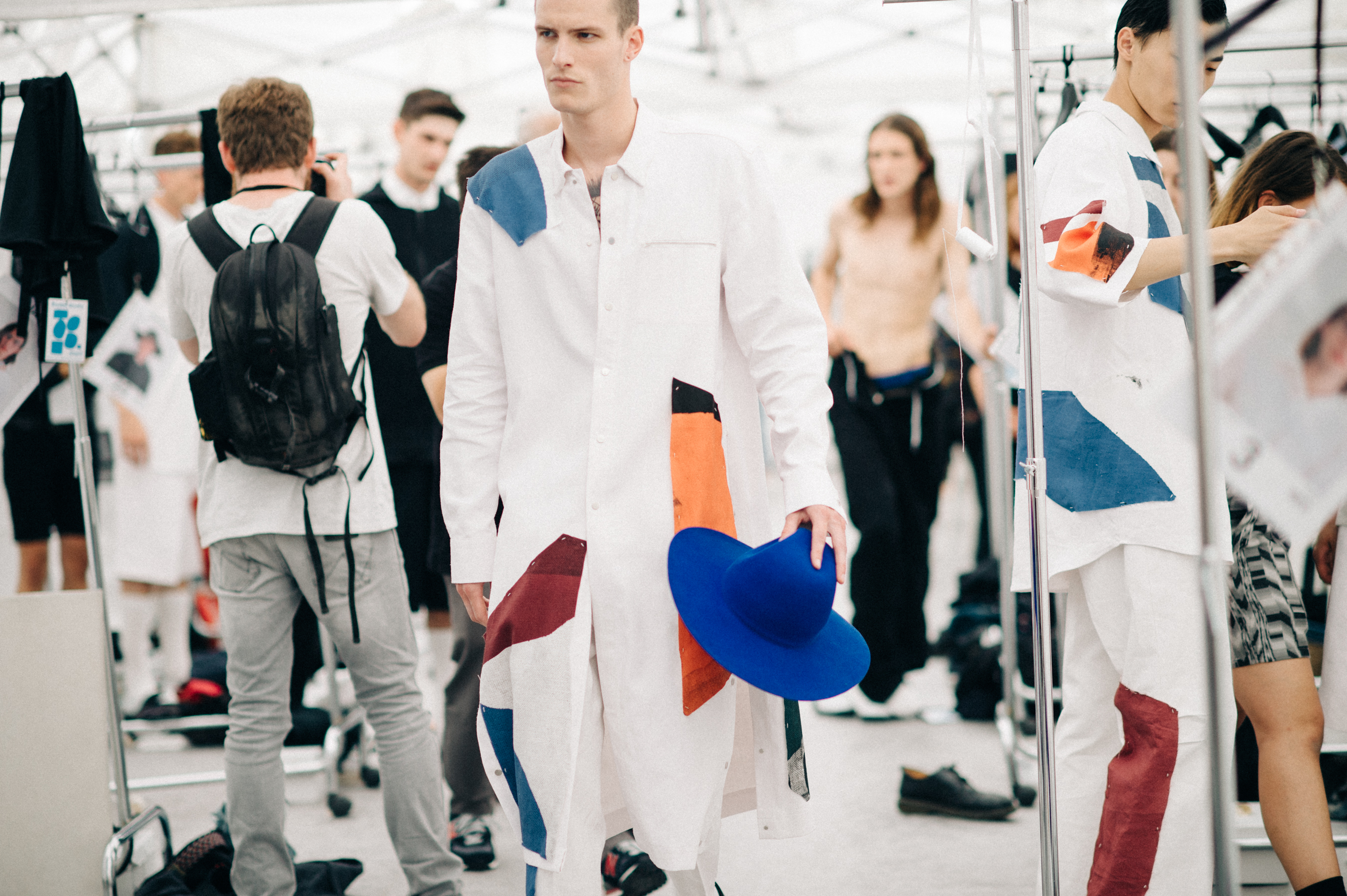 Male model in the dressing room in color detail suit
