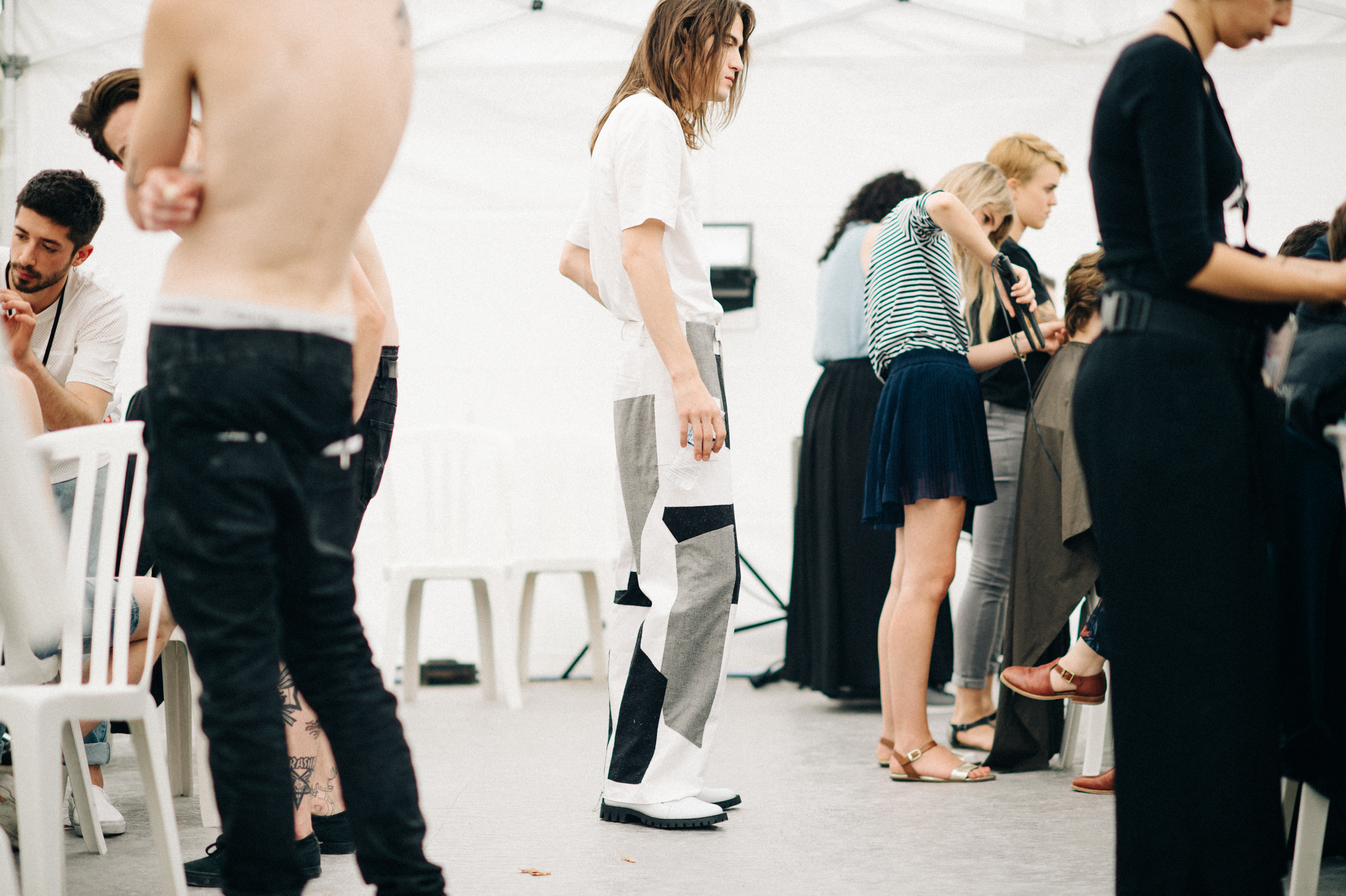 Male model wearing grey pants in the dressing room