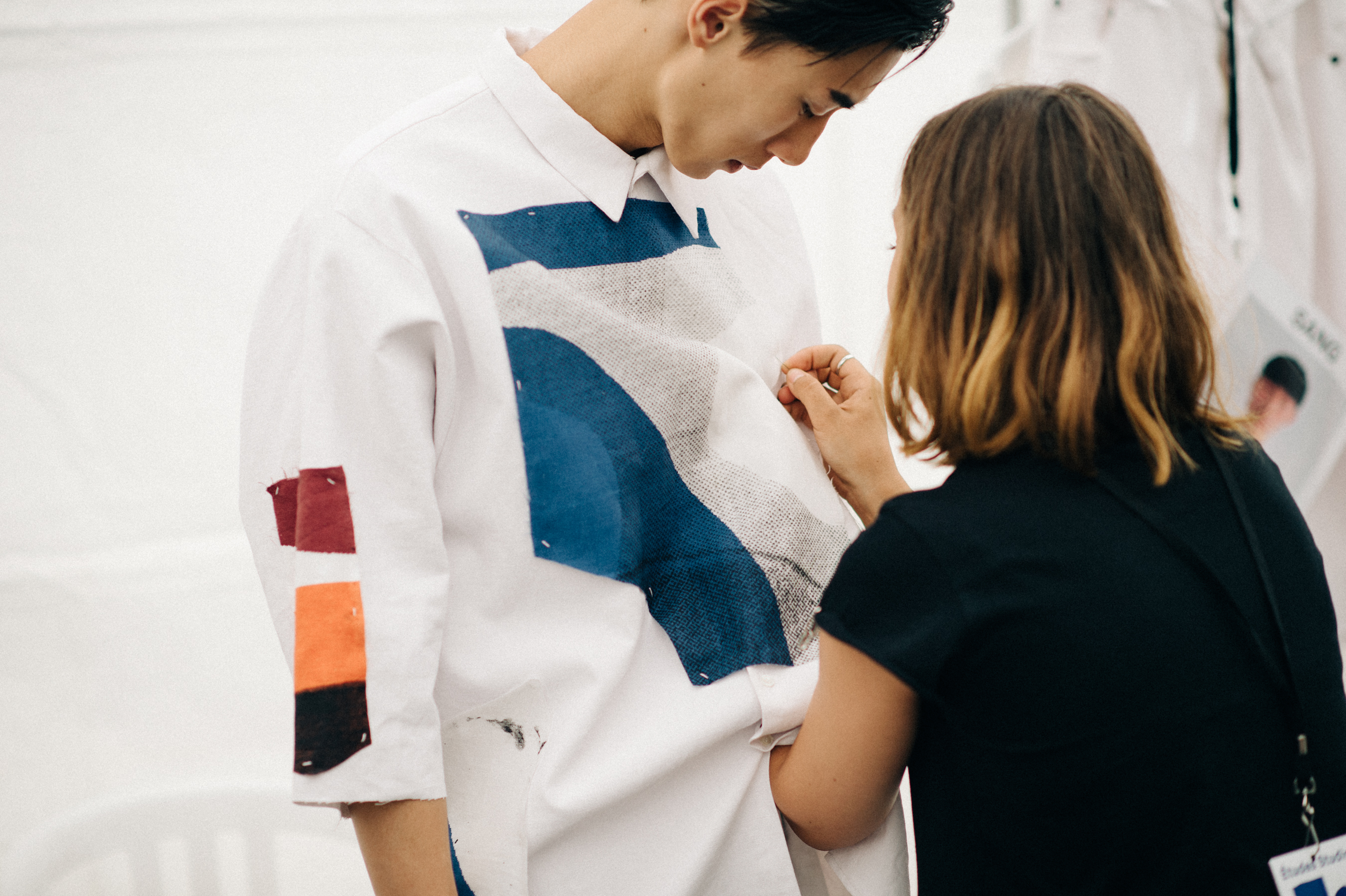 Asian male model getting dressed before the show
