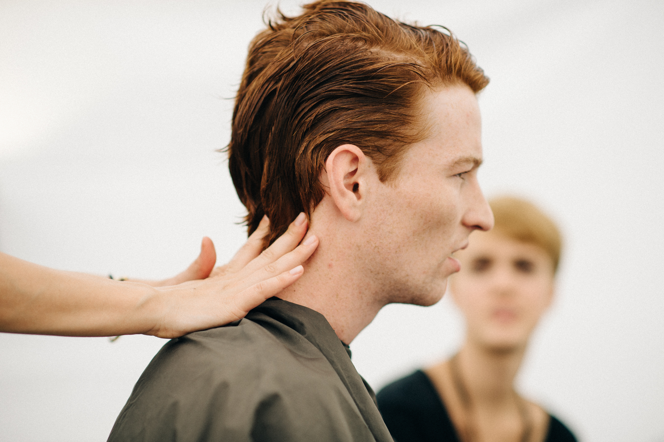 Male model with ginger hair getting his hair done
