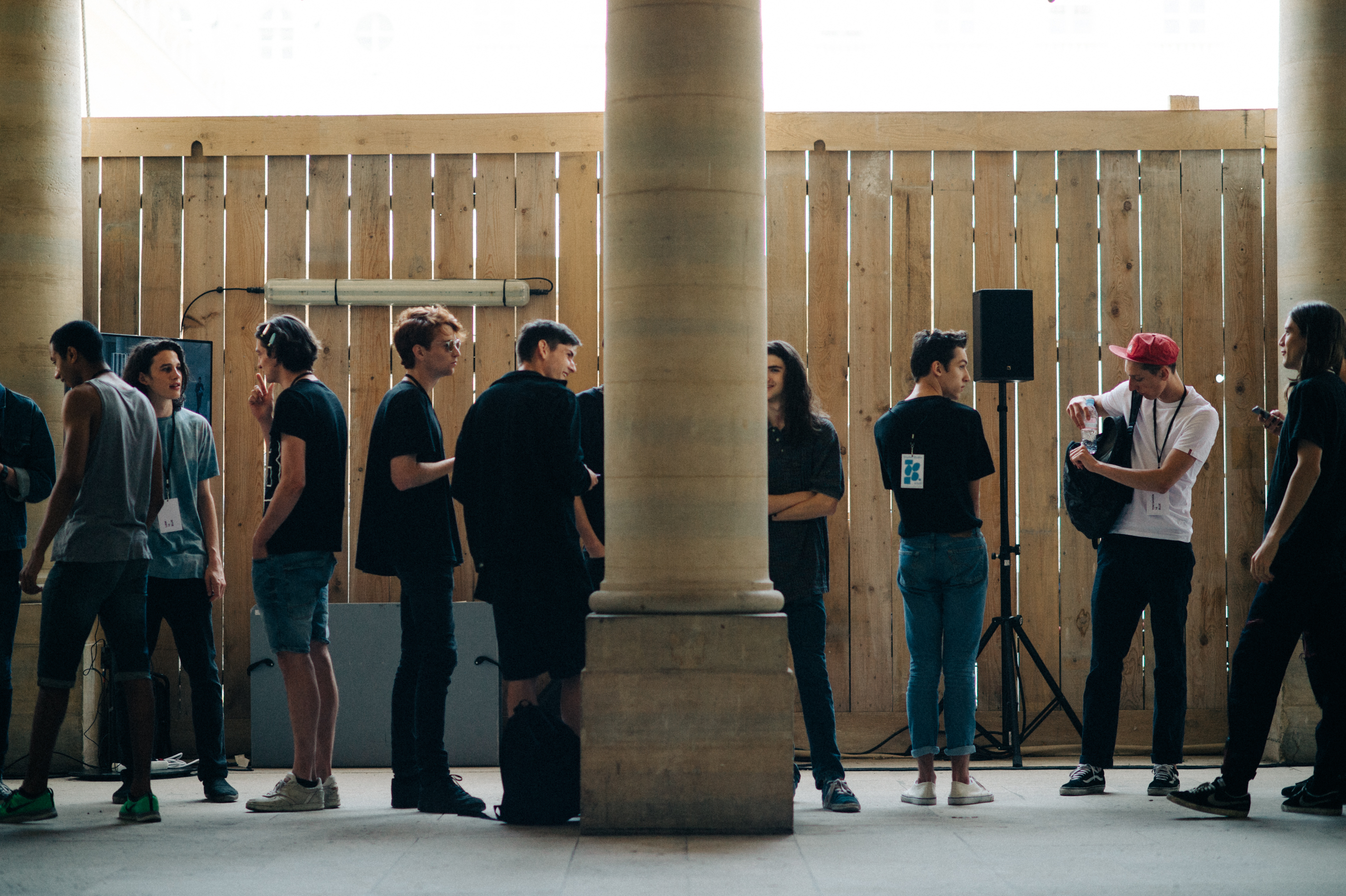Male models lined up before the fashion show rehearsal