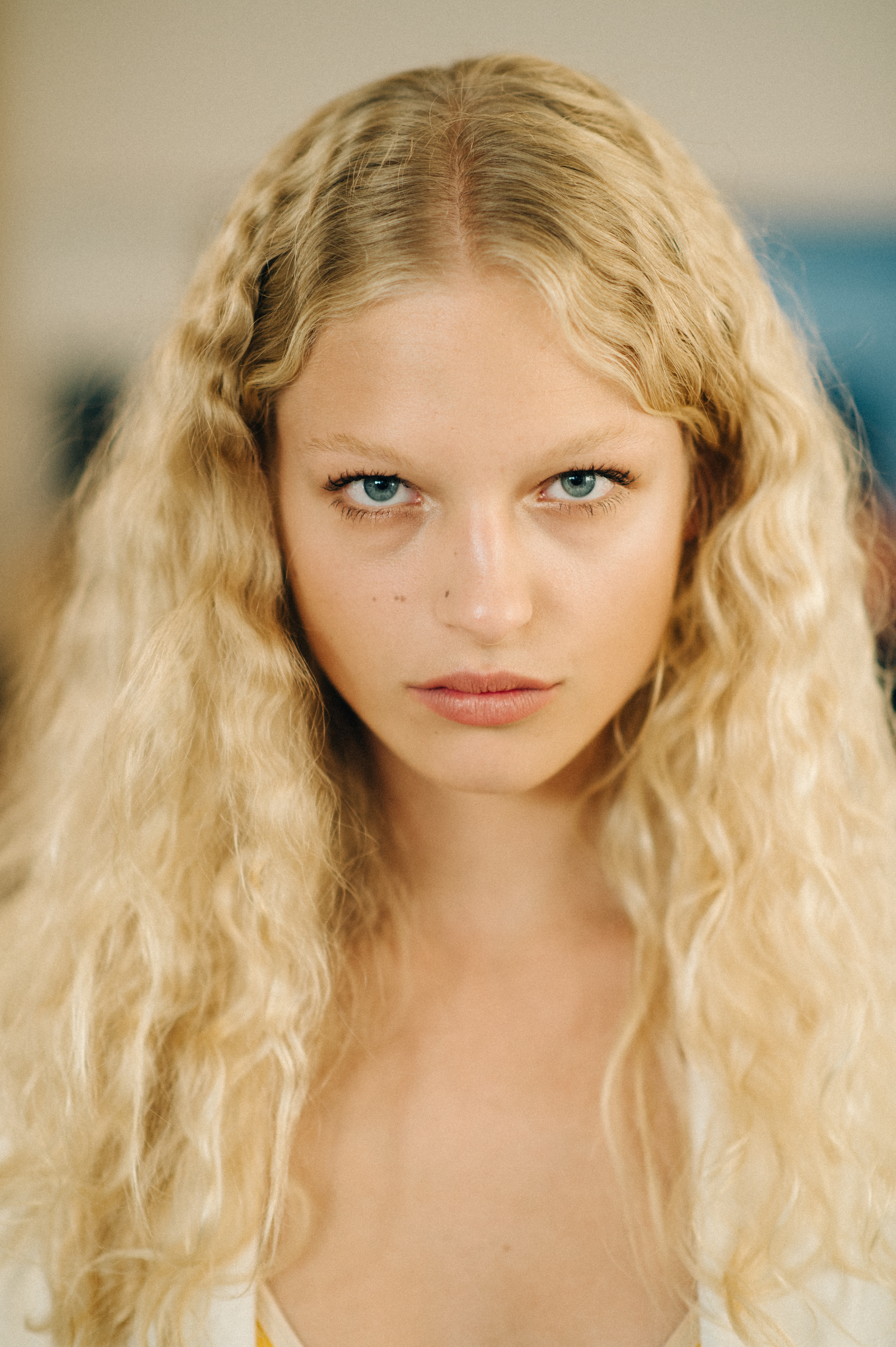 Portrait of a blonde Danish model with curly hair before the show