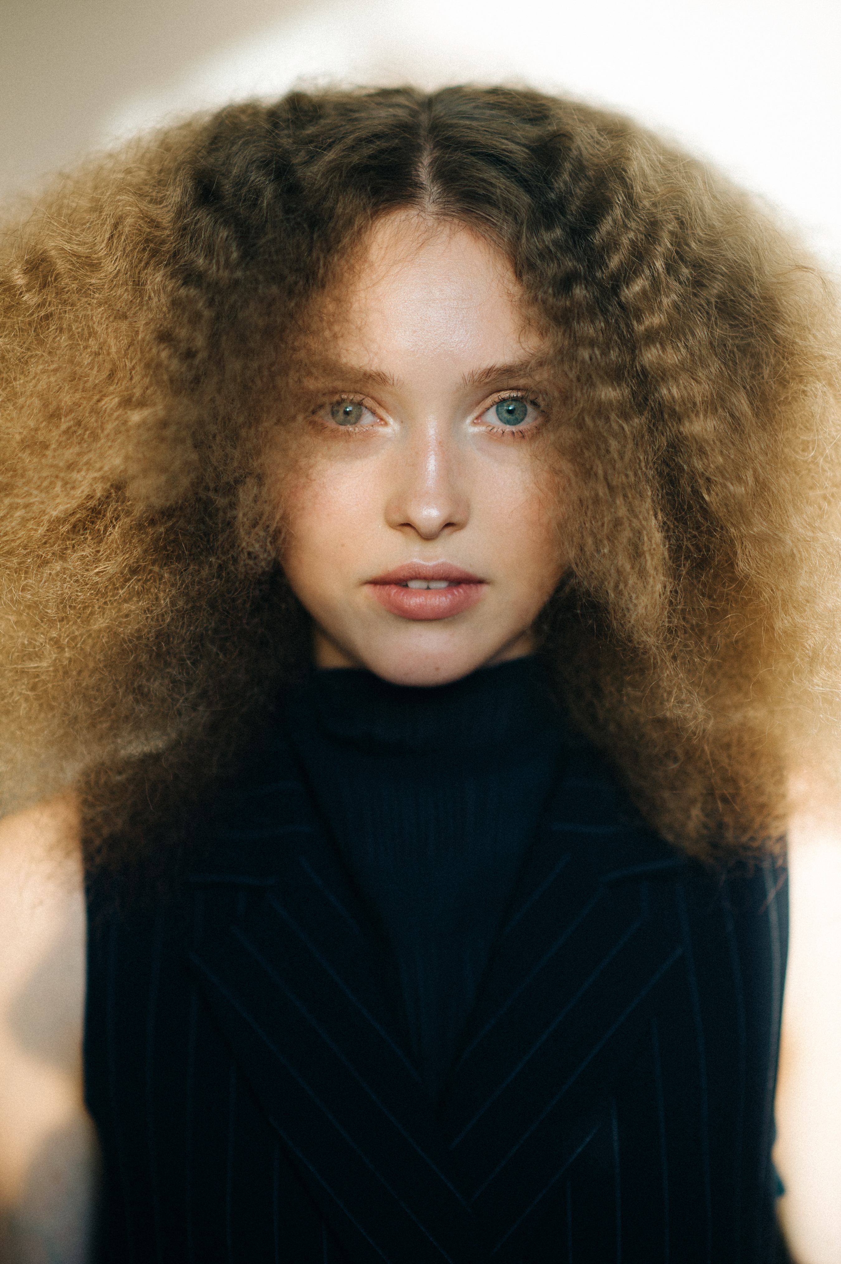Young model with big hair before the show