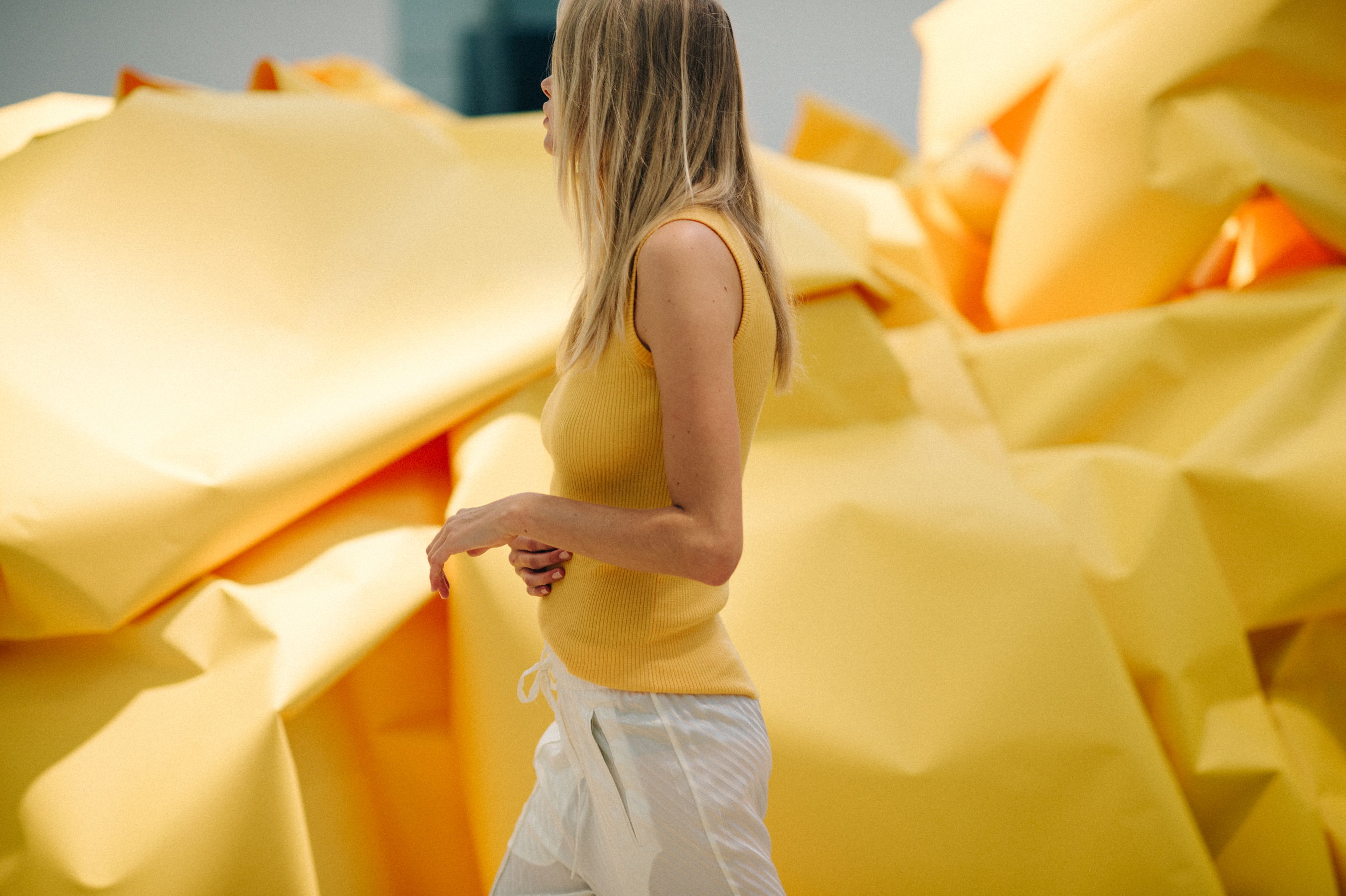 Model wearing yellow on the yellow catwalk decorations