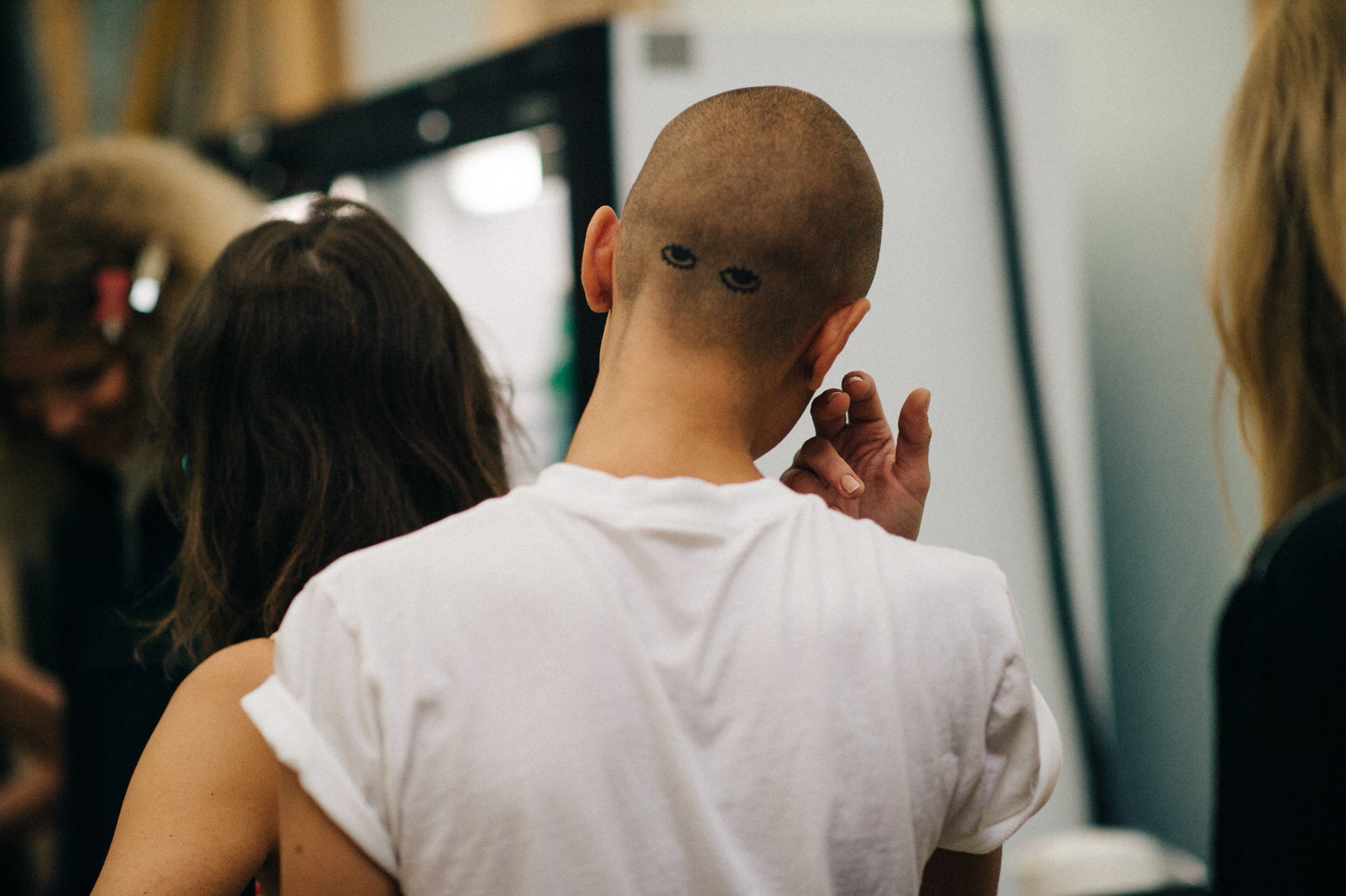 Model with short hair with tattoos on the back of her head