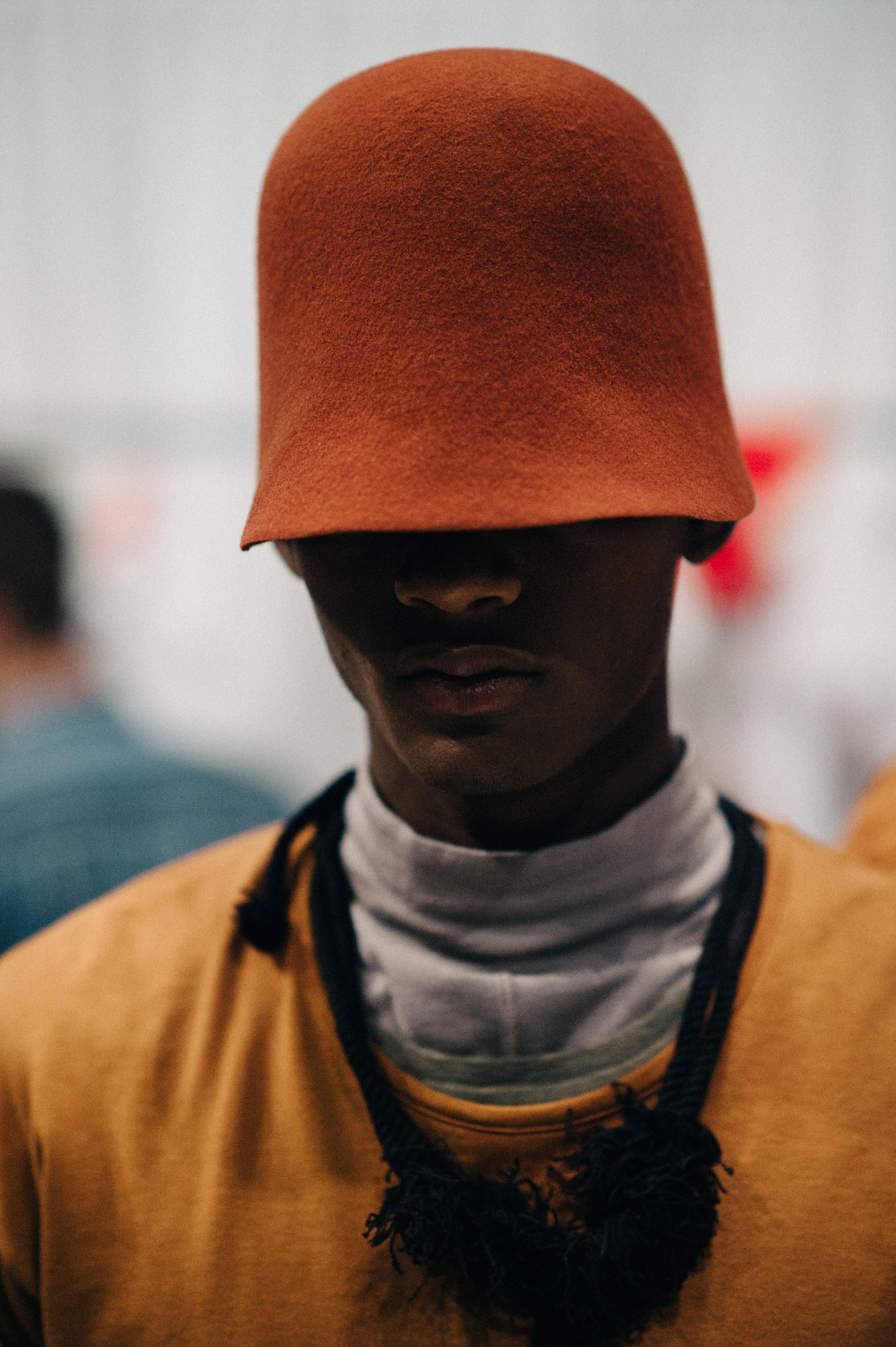 Male model wearing red hat before the show