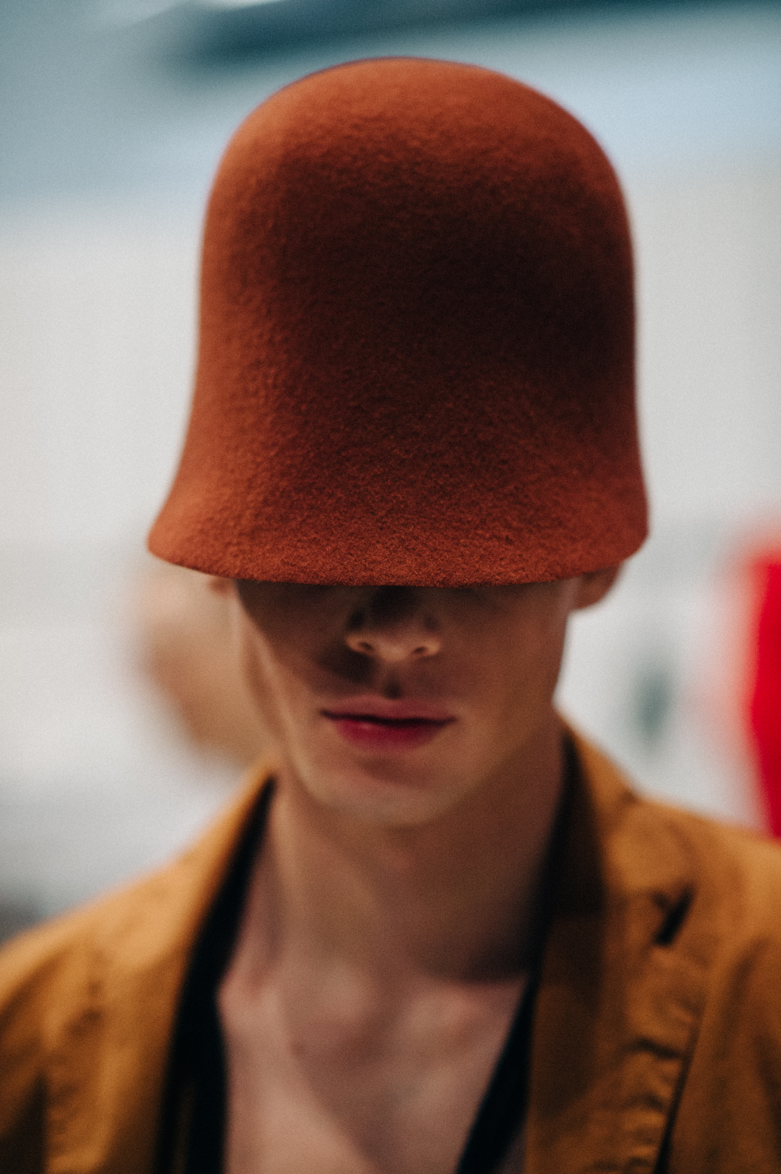 Male model wearing red hat before the show